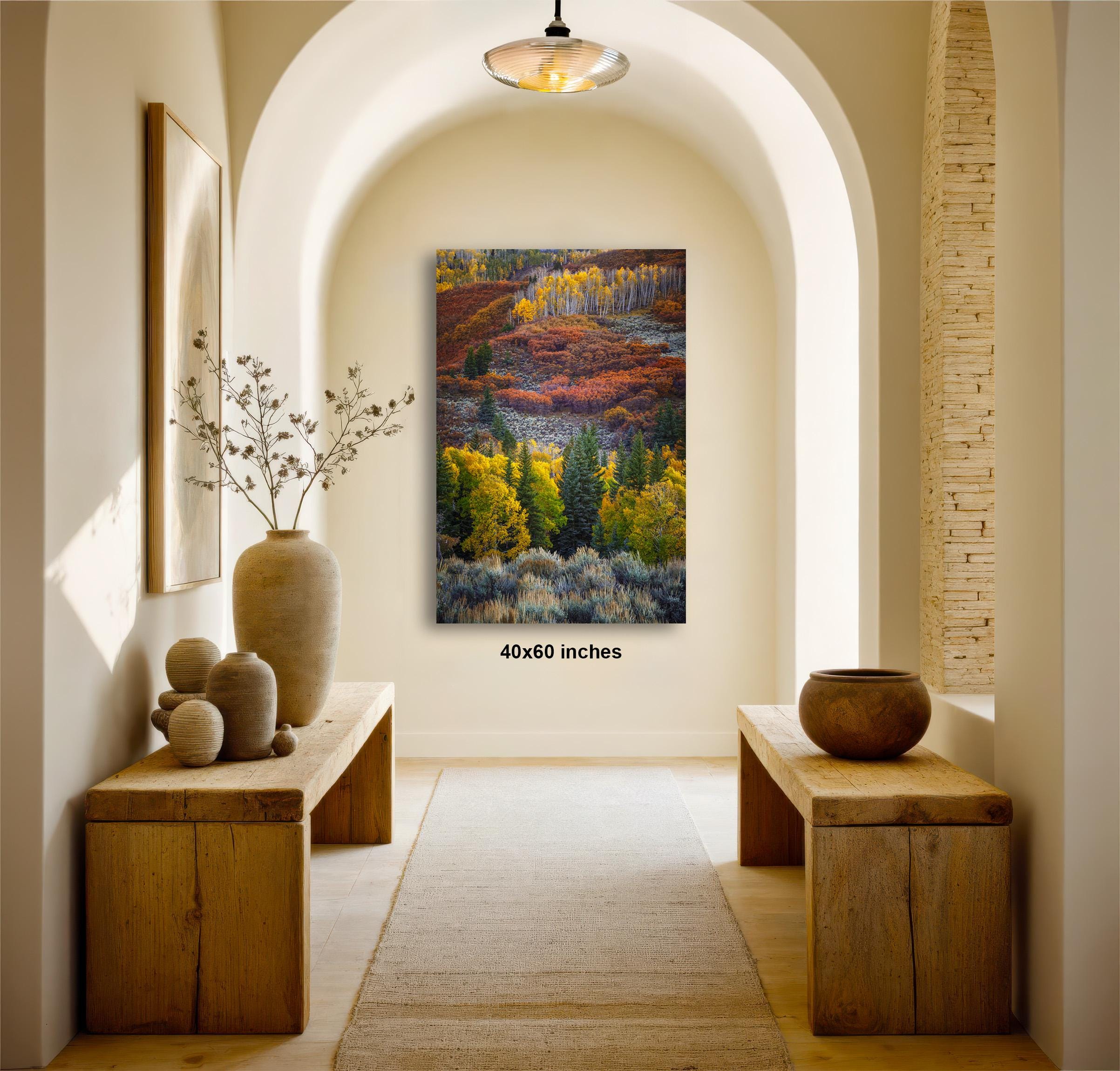 a hallway with a large painting hanging on the wall, featuring a colorful landscape with trees and a mountain. The painting is framed in a wooden frame and is approximately 4060 inches in size. The hallway has wooden benches on either side of the painting, and there are decorative vases and a potted plant on the tables. The overall atmosphere of the image is warm and inviting, with the natural elements of the painting and the wooden furniture creating a harmonious and comfortable space.