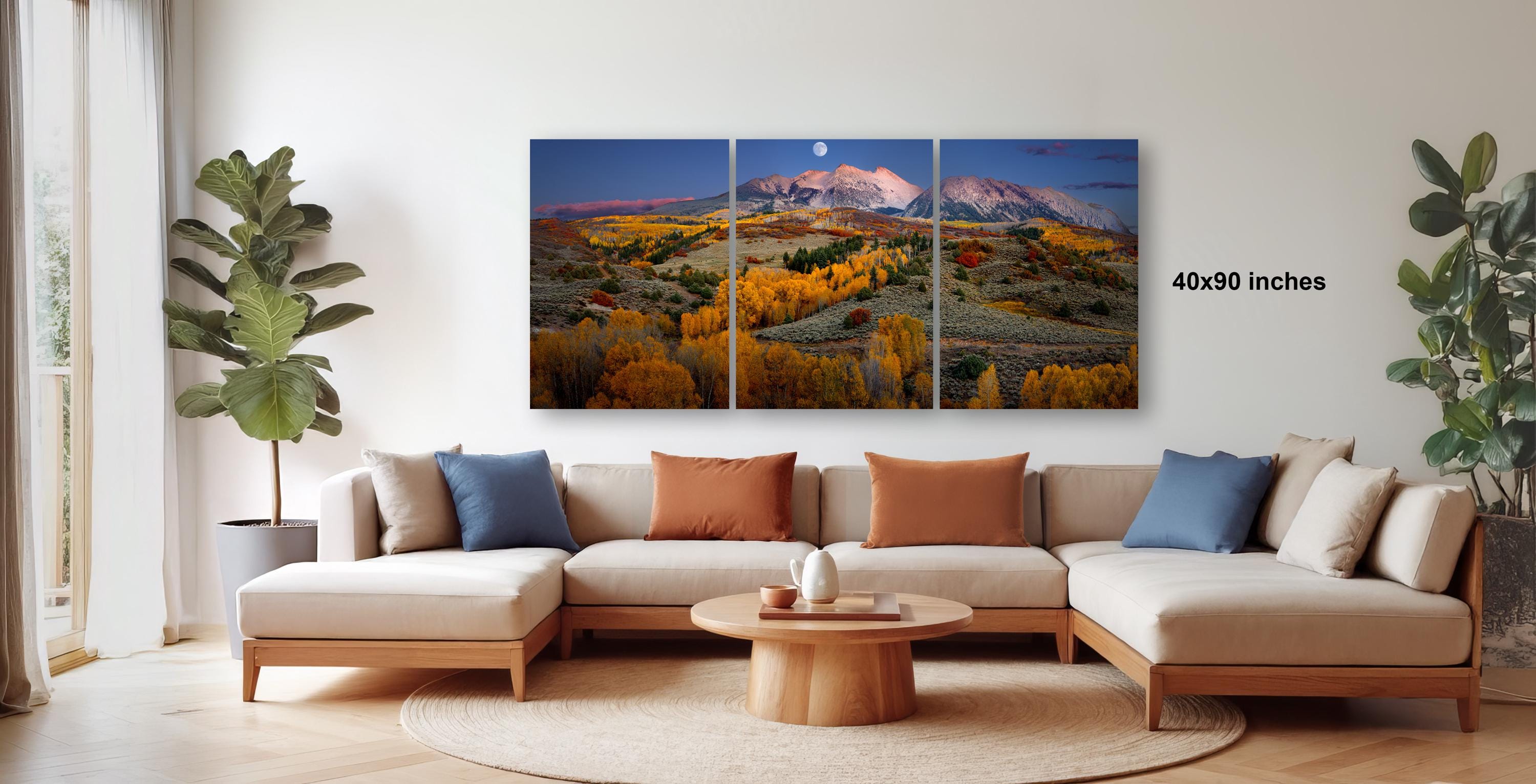a large, colorful landscape painting hanging on a wall in a living room.