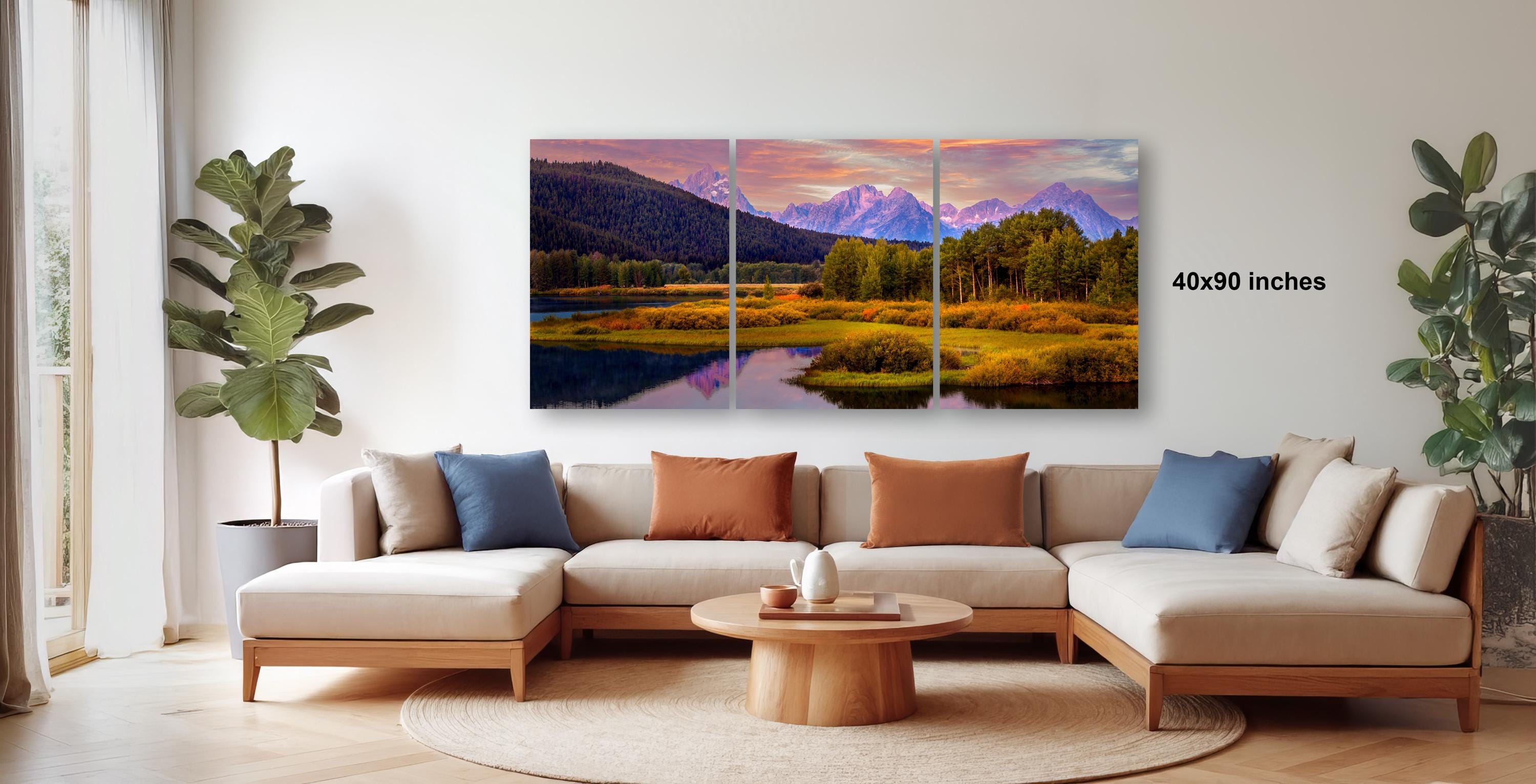 a large, three-panel landscape painting hanging on a wall in a living room.