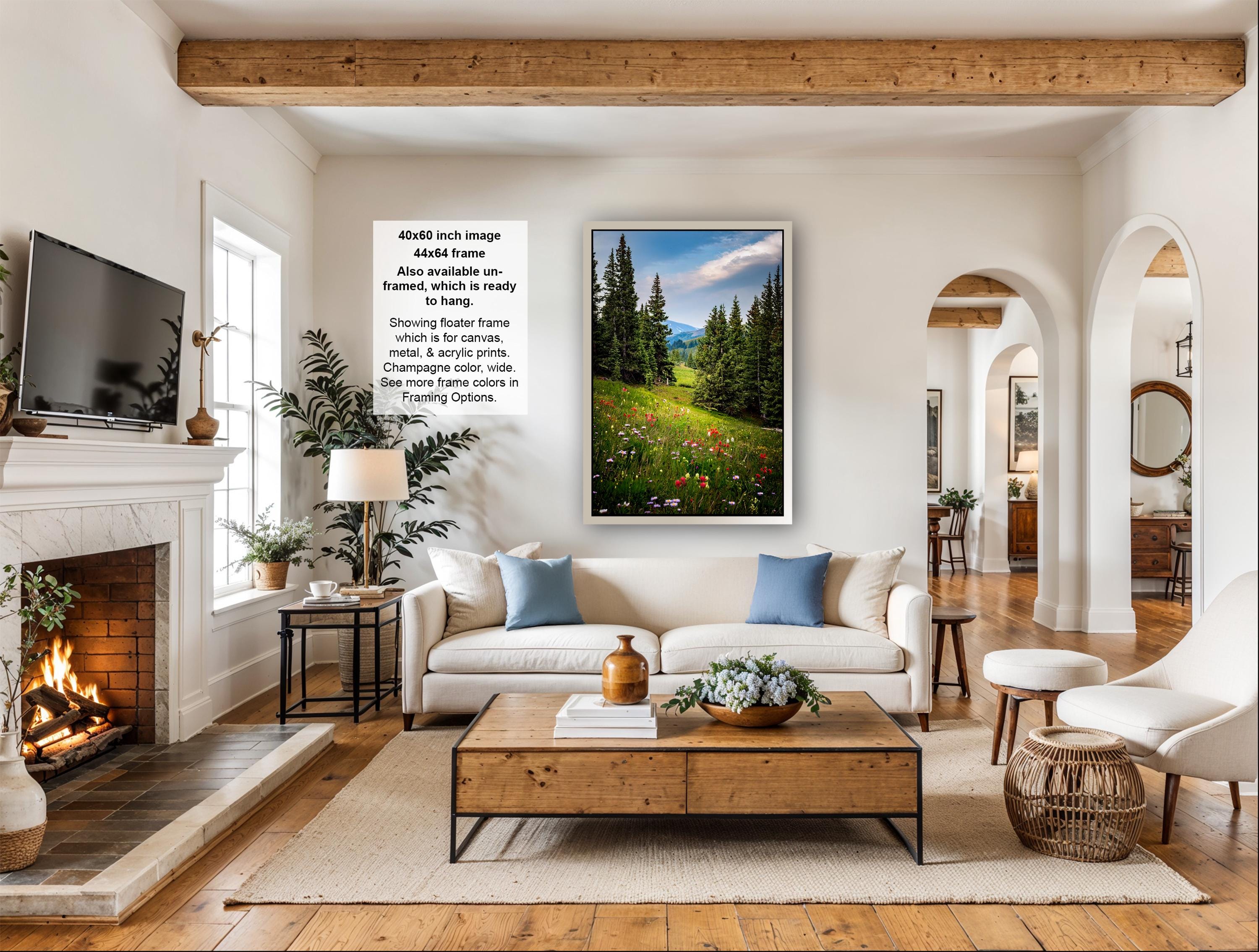 a cozy living room with a fireplace, a large window, a comfortable sofa, a coffee table, and a television.