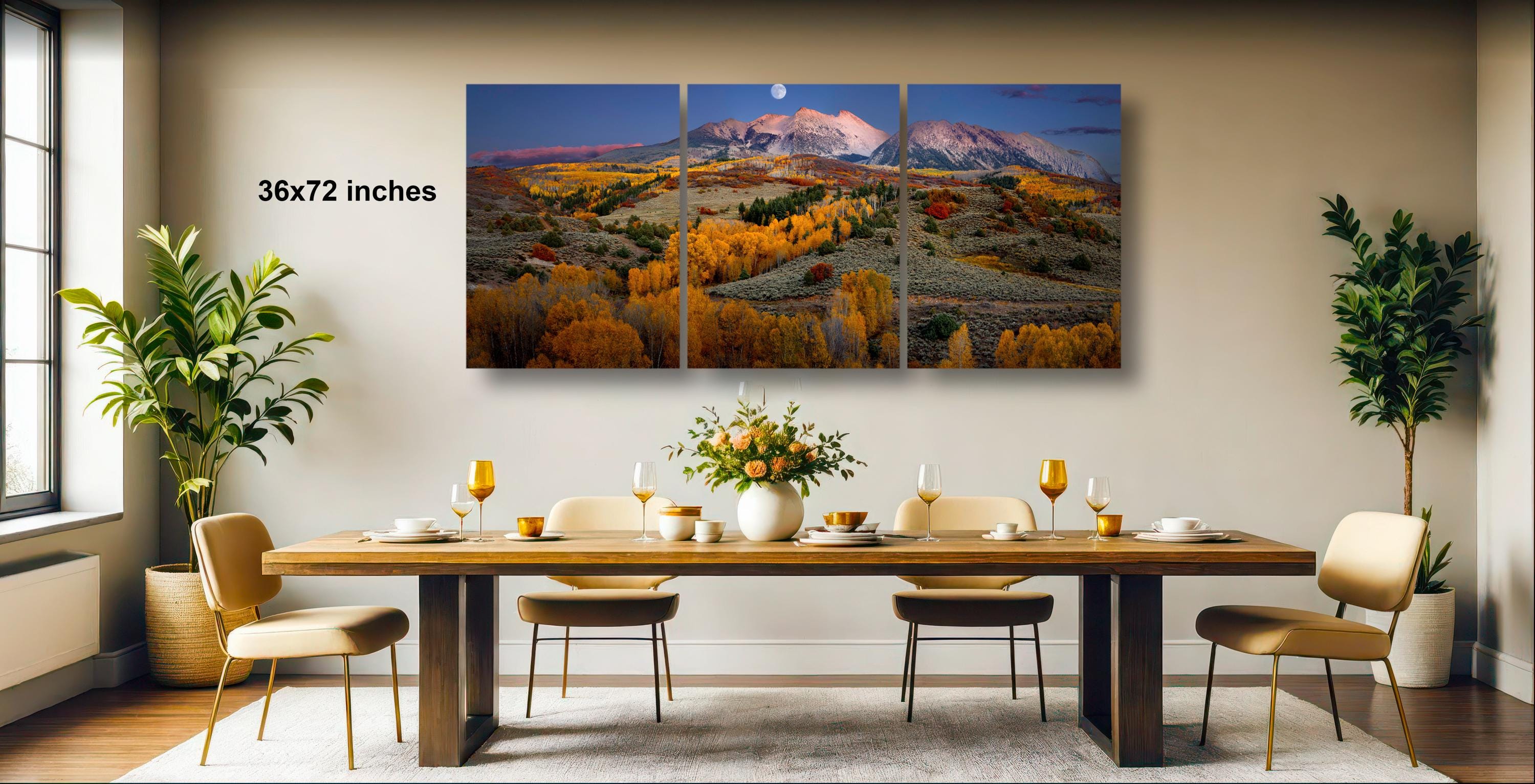 a large, multi-panel landscape painting hanging on a wall above a wooden dining table set with wine glasses, plates, and a vase of flowers.