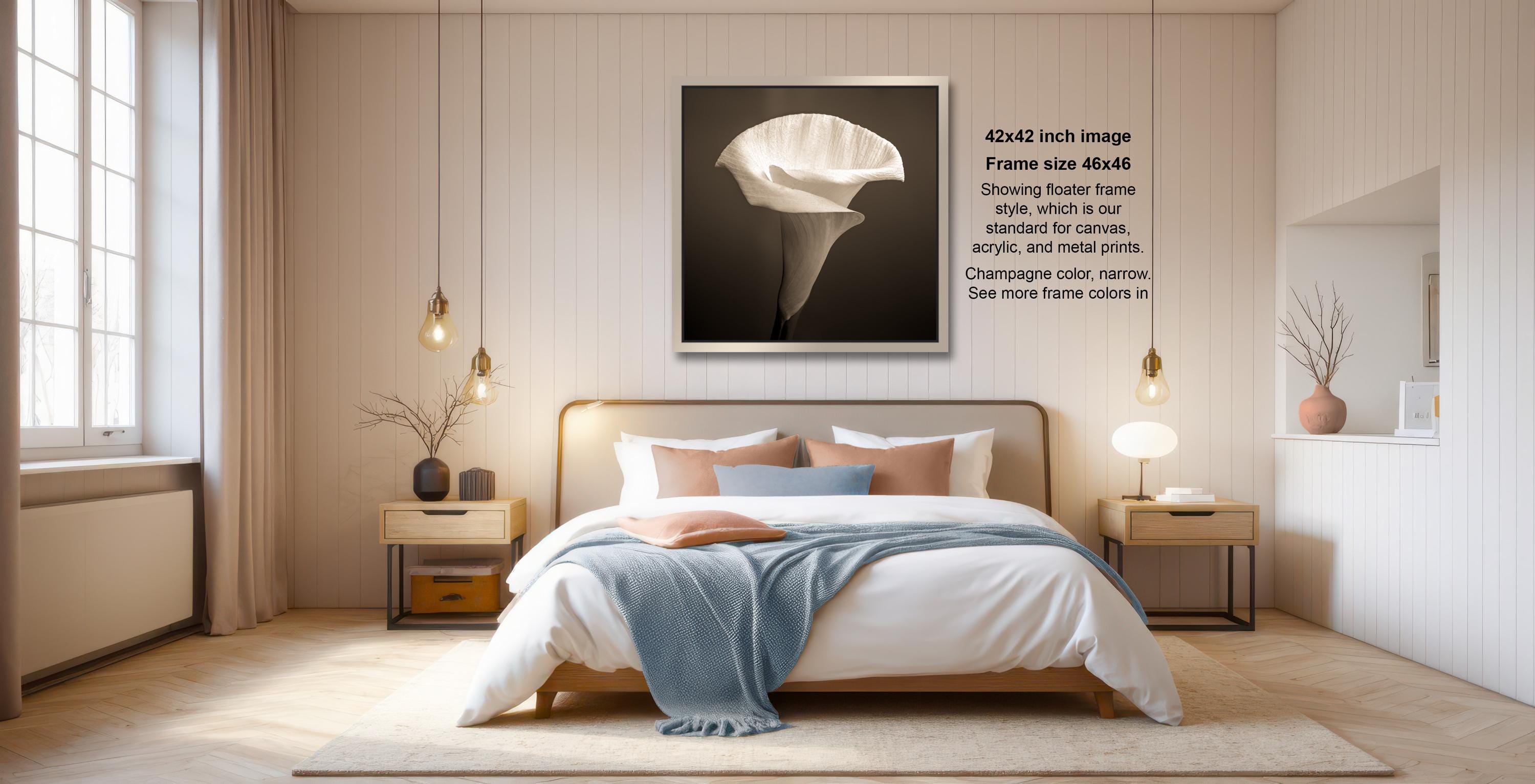 a serene and modern bedroom with a large bed, wooden furniture, and a large framed artwork hanging on the wall.