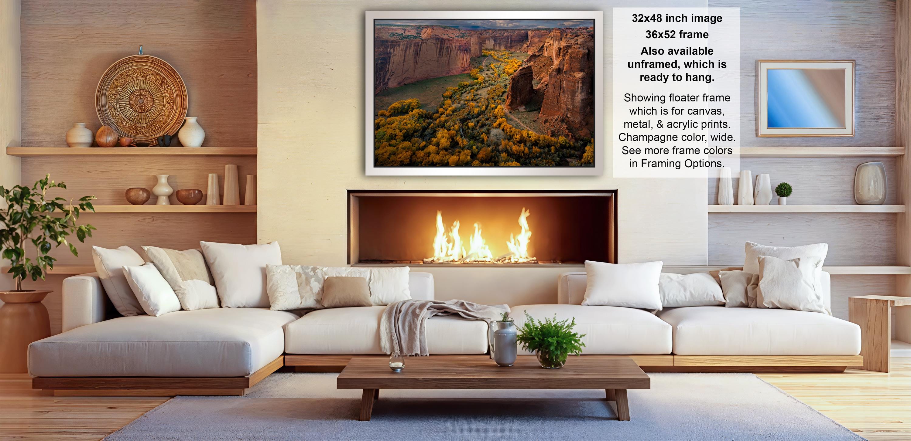 a modern living room with a large white sectional sofa, a fireplace, and a wooden coffee table. The room has a warm and inviting atmosphere, with decorative elements such as vases, potted plants, and a mirror on the wall.