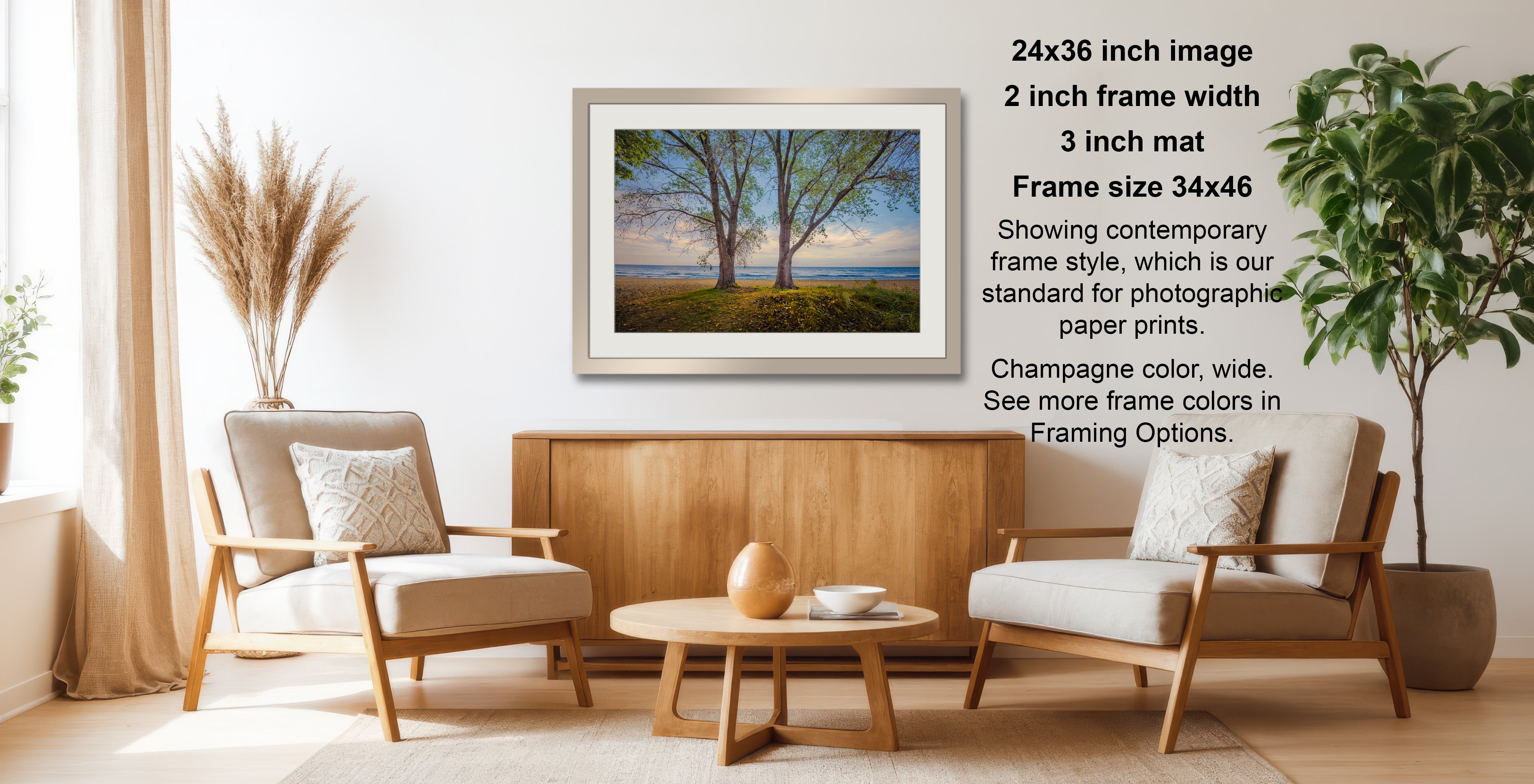 a cozy living room with a wooden coffee table, two beige armchairs, and a framed landscape photograph hanging on the wall.