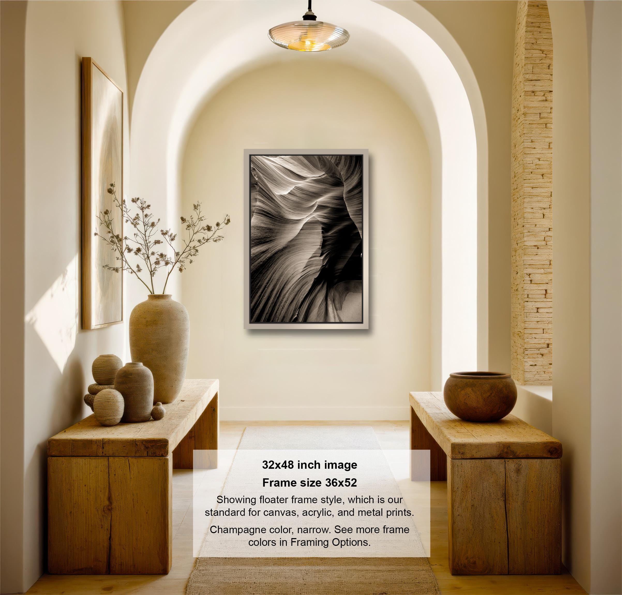 The image is a 32x48-inch framed photograph of a black and white abstract image hanging on a wall in a hallway.