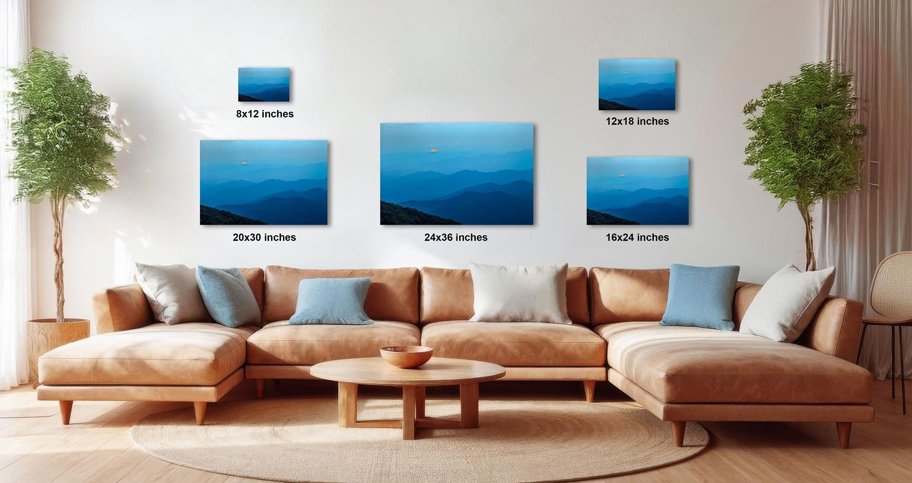 a living room with a large sectional sofa, a coffee table, and several framed landscape photographs displayed on the wall.
