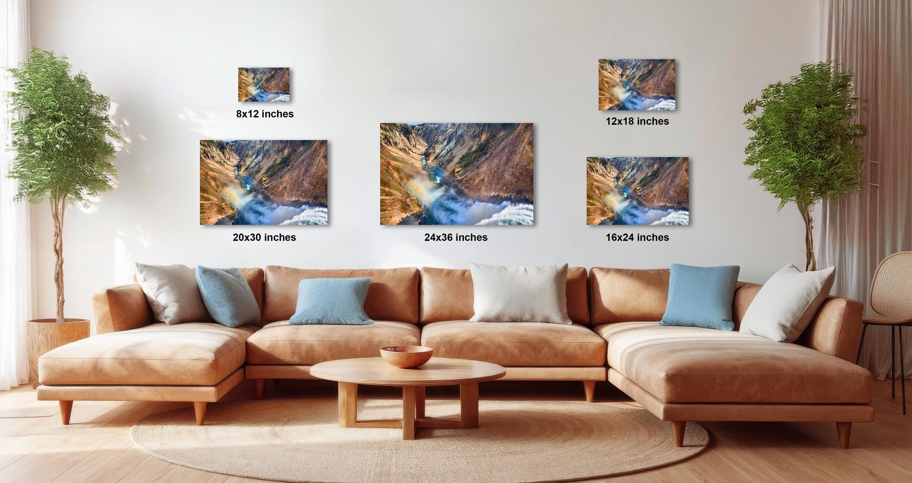 a modern living room with a large sectional sofa, a coffee table, and several potted plants. The walls are decorated with three framed landscape photographs, each with a different size and resolution, ranging from 12x12 inches to 16x16 inches.