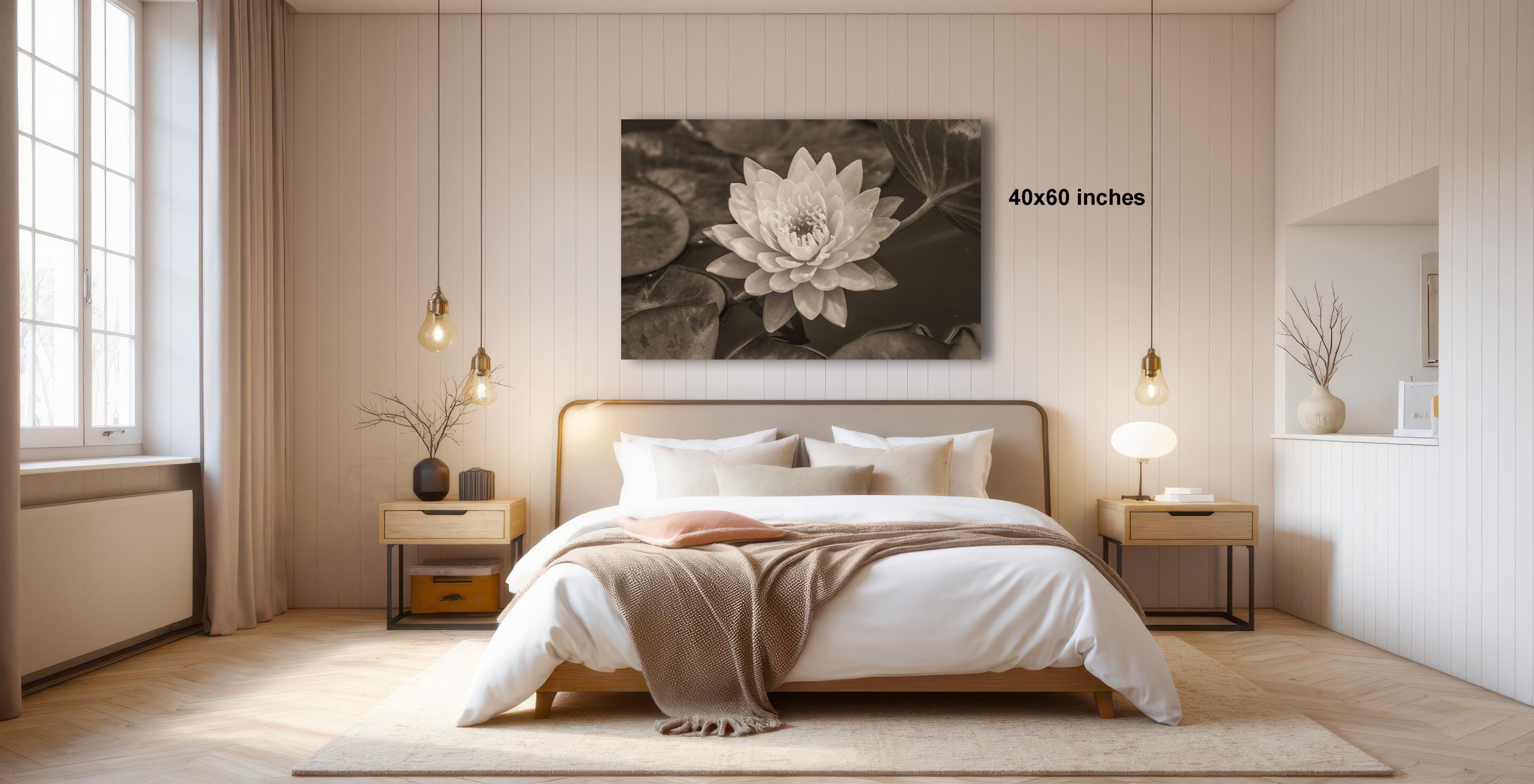 a serene and modern bedroom with a large bed, wooden furniture, and a large black and white photograph of a flower hanging above it.