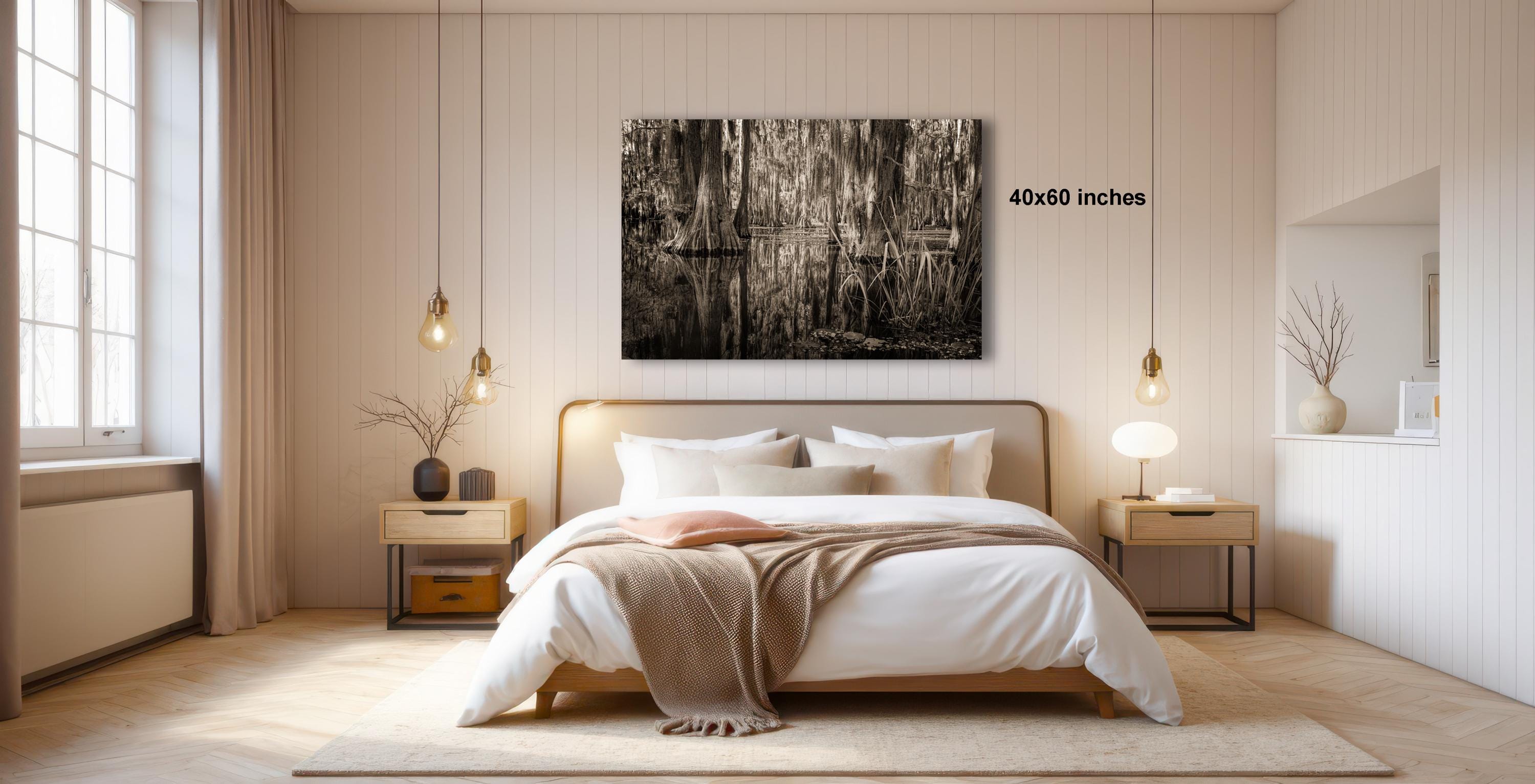a serene and modern bedroom with a large bed, wooden furniture, and a large black and white photograph hanging on the wall.