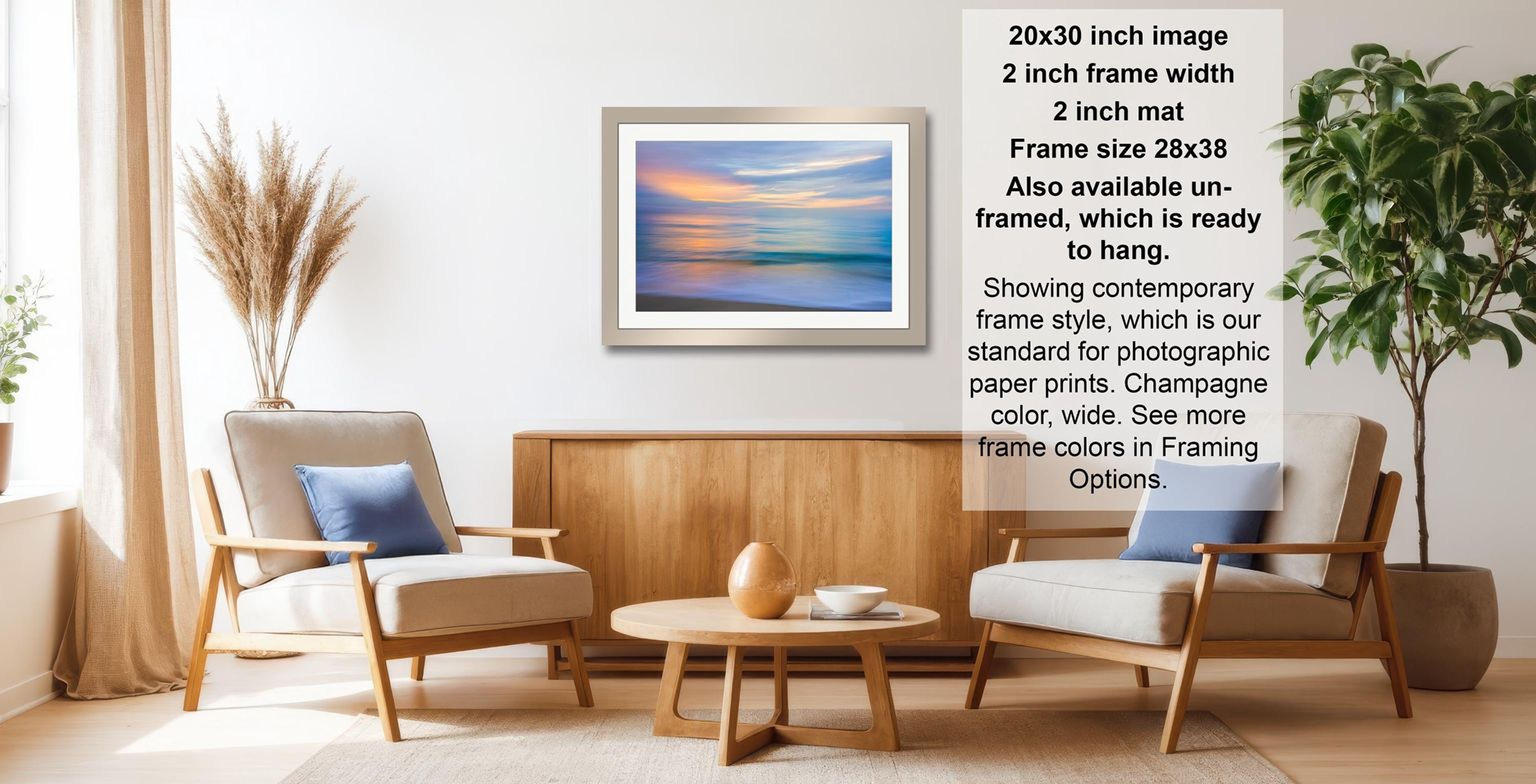a living room with a framed landscape painting hanging on the wall, two chairs, a coffee table, and a potted plant.