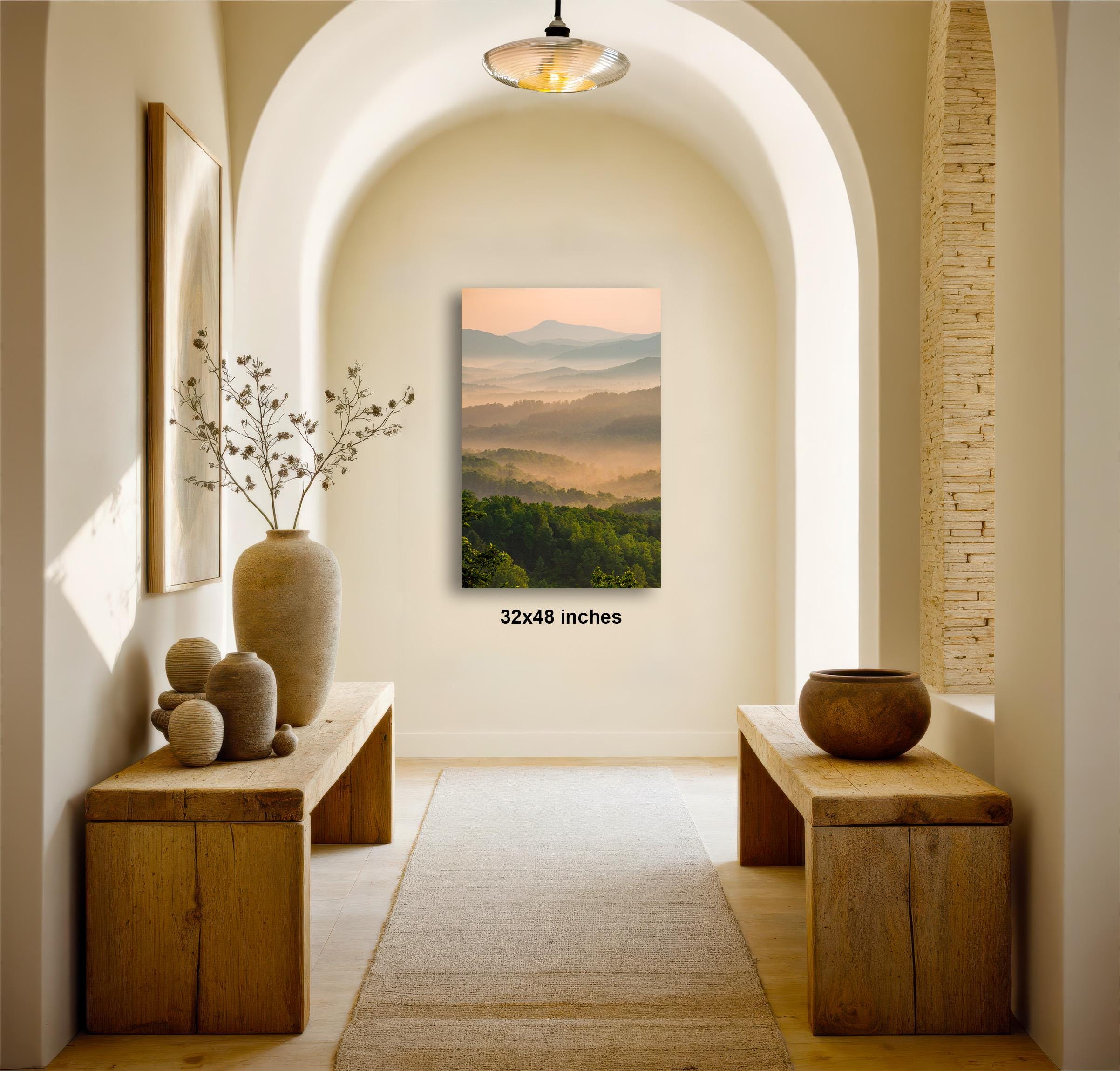 a serene and inviting hallway with a large painting of a mountainous landscape hanging on the wall. The painting is framed in a wooden frame and measures 32x48 inches in size. The hallway features wooden benches and tables, as well as decorative elements such as a vase and a bowl. The overall atmosphere of the hallway is calm and peaceful, with the natural landscape painting serving as a focal point.