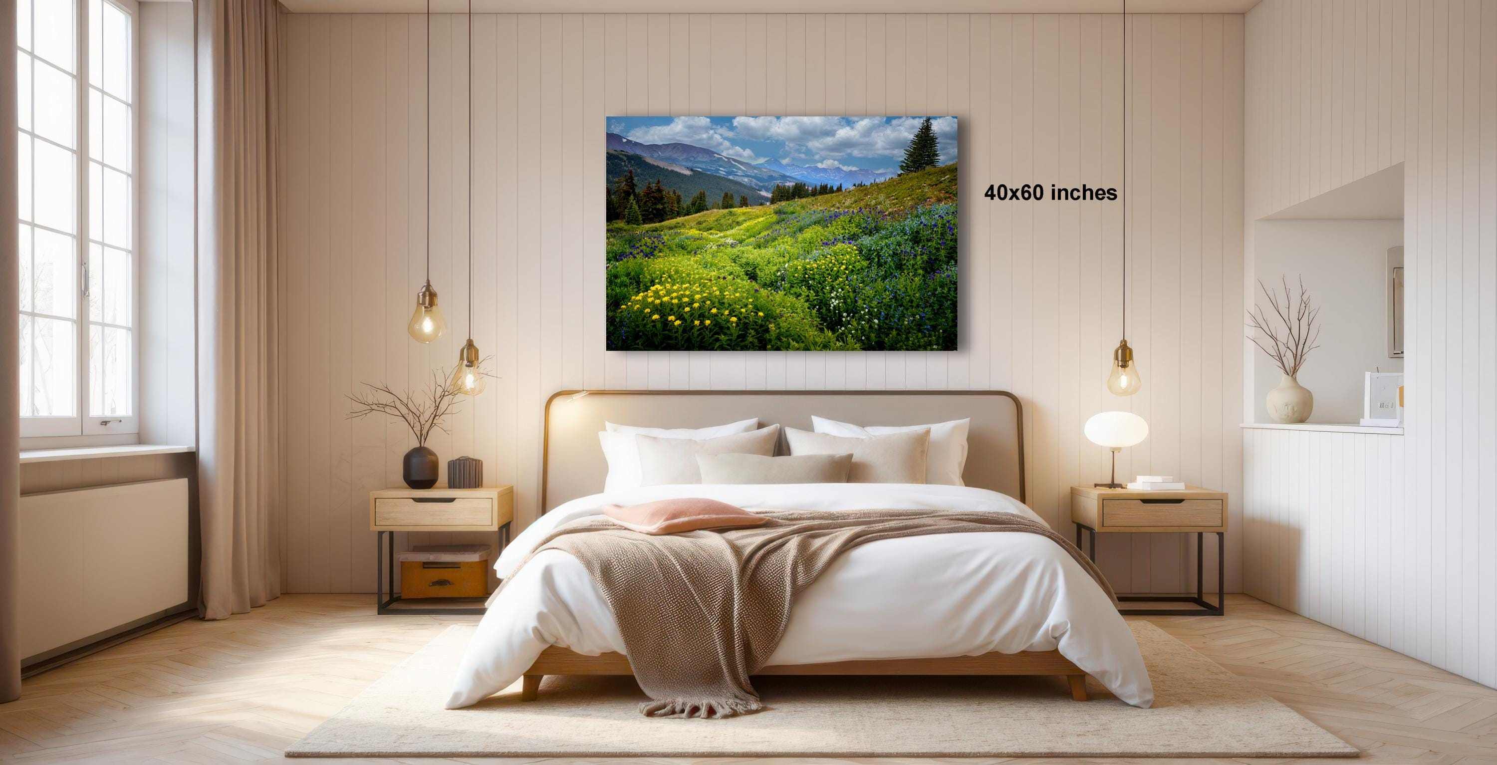 a serene bedroom with a large bed, wooden furniture, and a painting of a lush green field with yellow flowers hanging above it.