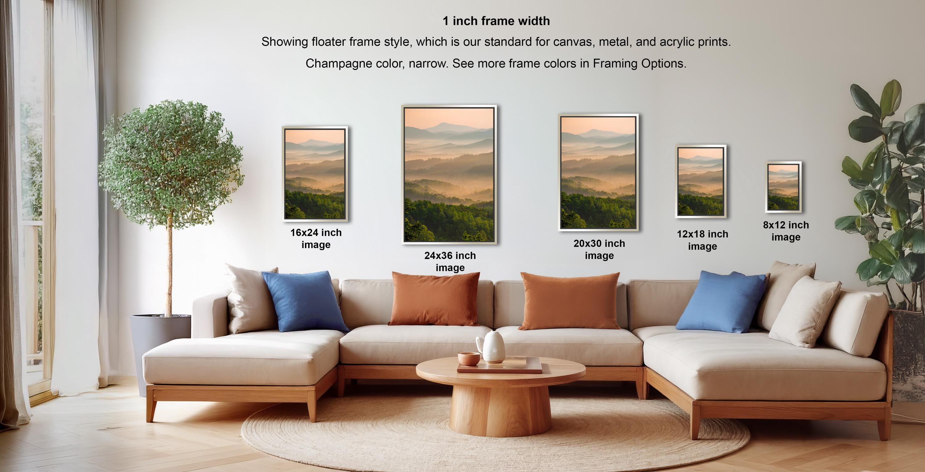a living room with a large sectional sofa and a coffee table. There are four framed landscape paintings displayed on the wall, each with a different frame size ranging from 16.24 to 24.26 inches. The paintings feature a variety of colors and frame styles, creating a visually appealing and diverse display.
