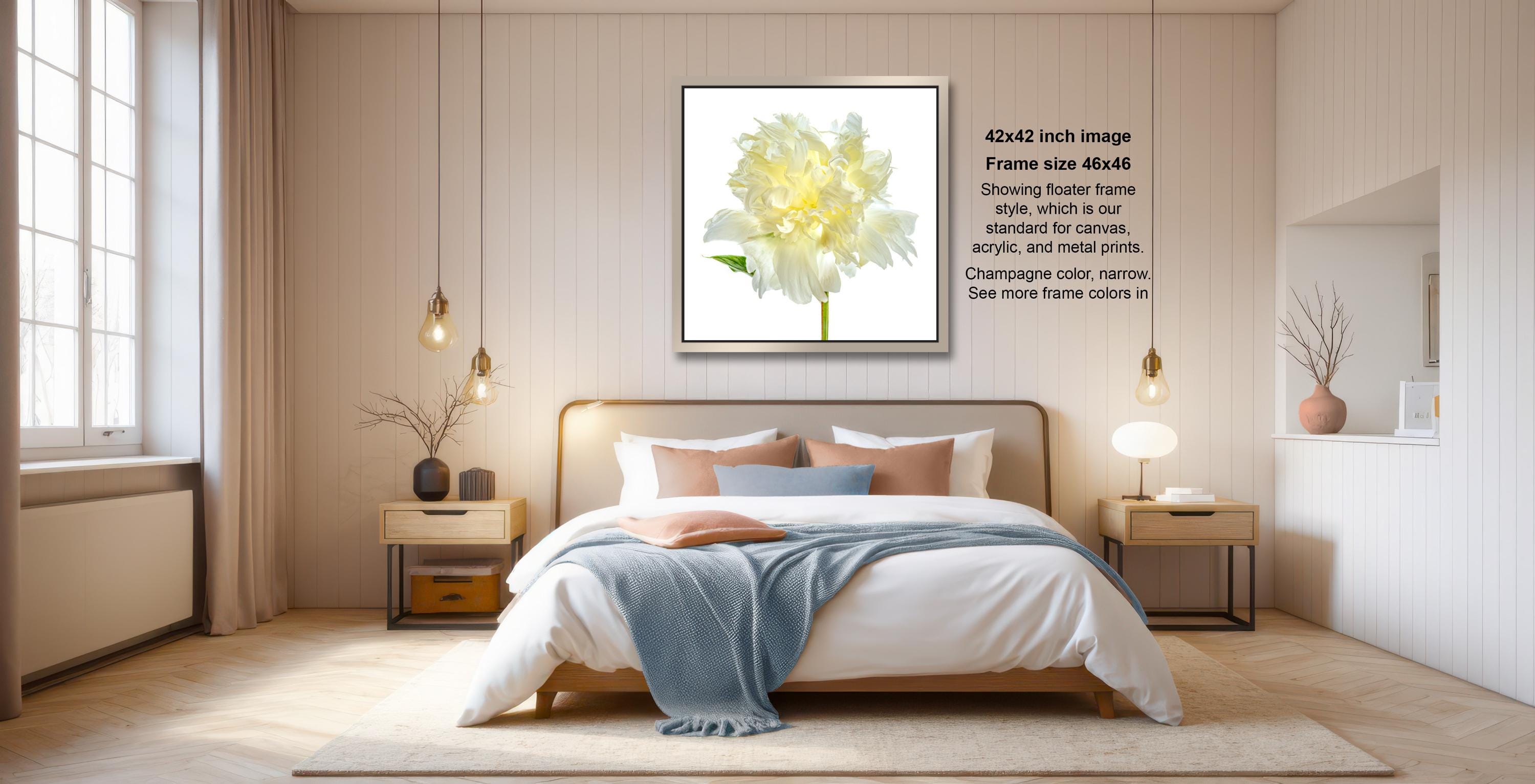 a serene and well-decorated bedroom with a large bed, wooden furniture, and a framed picture of a yellow flower on the wall.