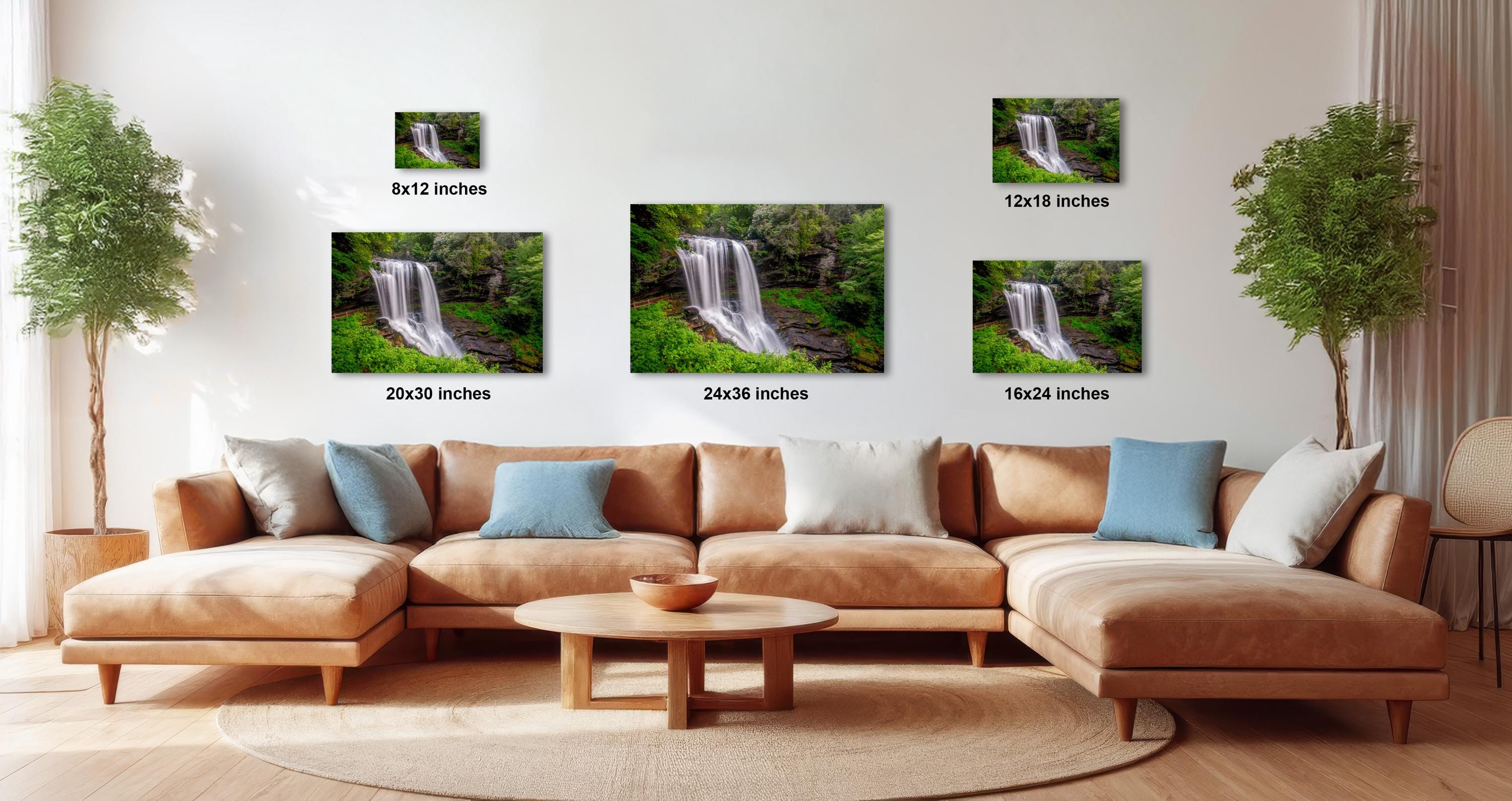 The image is a modern living room with a large sectional sofa, a coffee table, and several potted plants. The wall is decorated with three framed photographs of waterfalls, each with a different size and resolution. The photographs are arranged in a grid format, with one on the top left, one on the top right, and one on the bottom left. The text next to each photograph indicates the size of the image in inches.