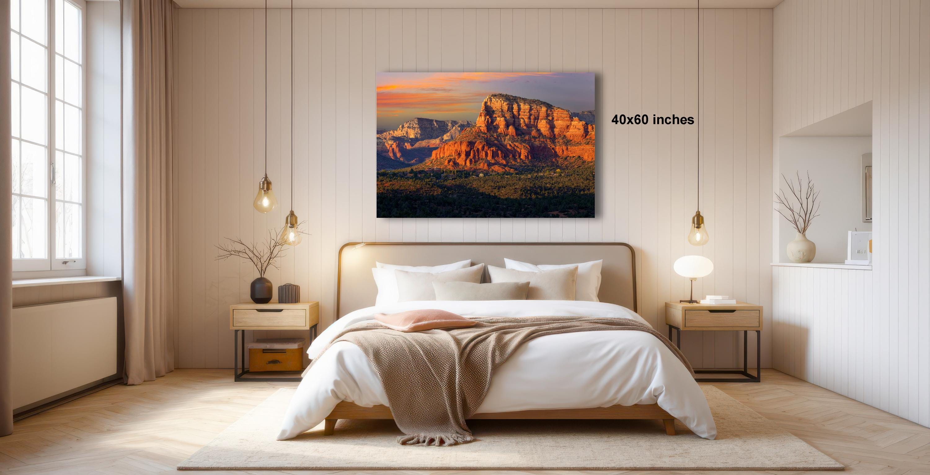 a serene bedroom with a large bed, wooden nightstands, and a painting of a mountain landscape hanging on the wall.