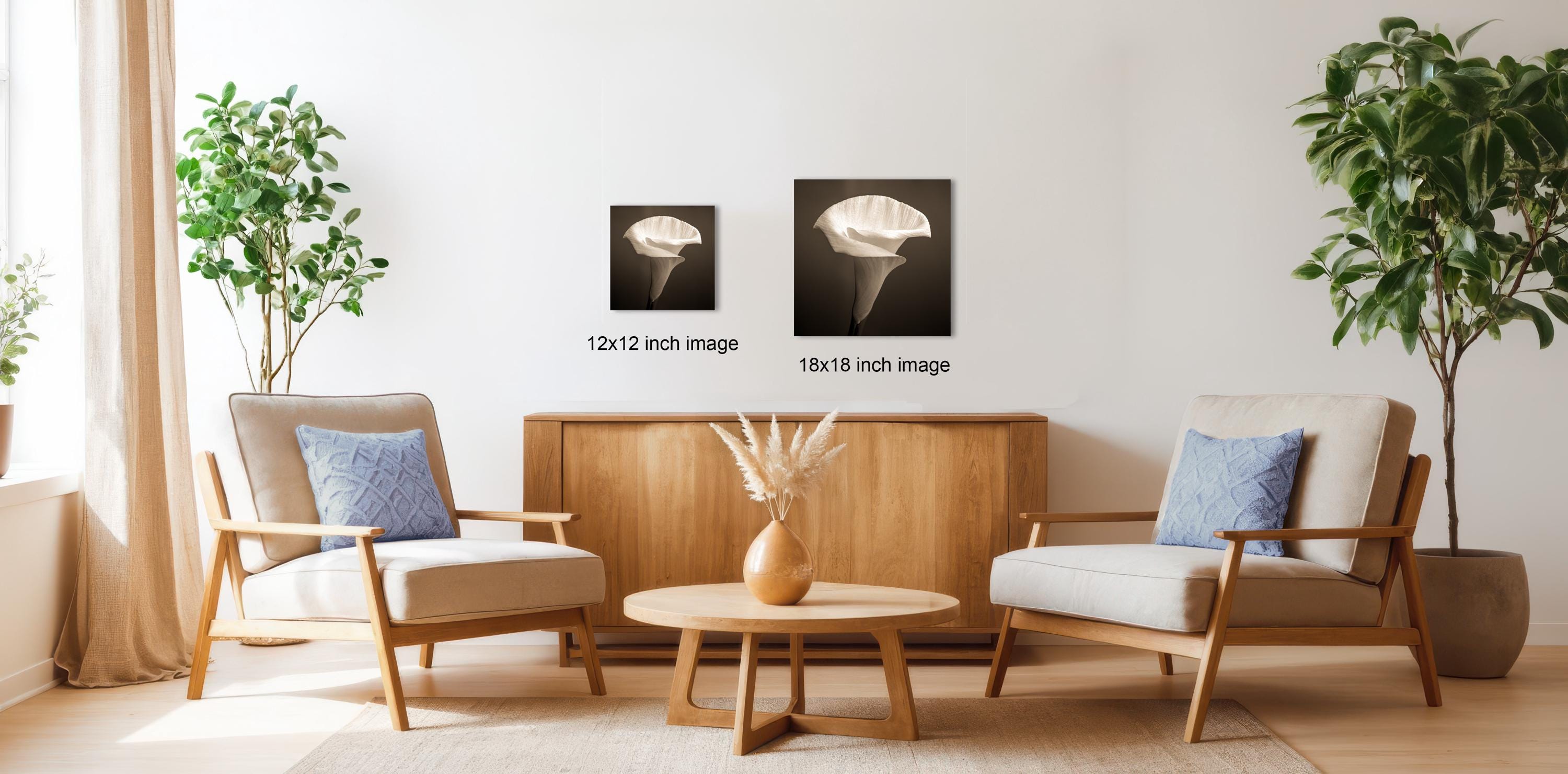 a cozy living room with two comfortable armchairs, a wooden coffee table, and a vase of flowers. The room is decorated with potted plants and has a warm, inviting atmosphere.