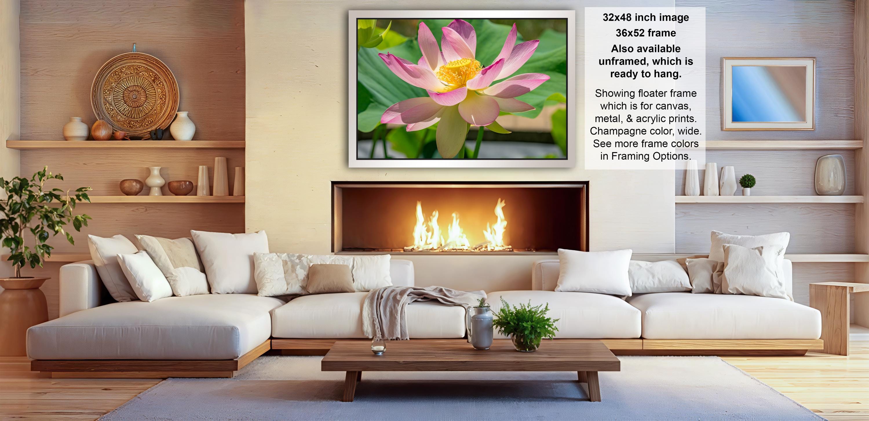 a cozy living room with a large white sectional sofa, a wooden coffee table, and a fireplace with a fire burning. The room is decorated with various vases, potted plants, and other home decor items, creating a warm and inviting atmosphere.