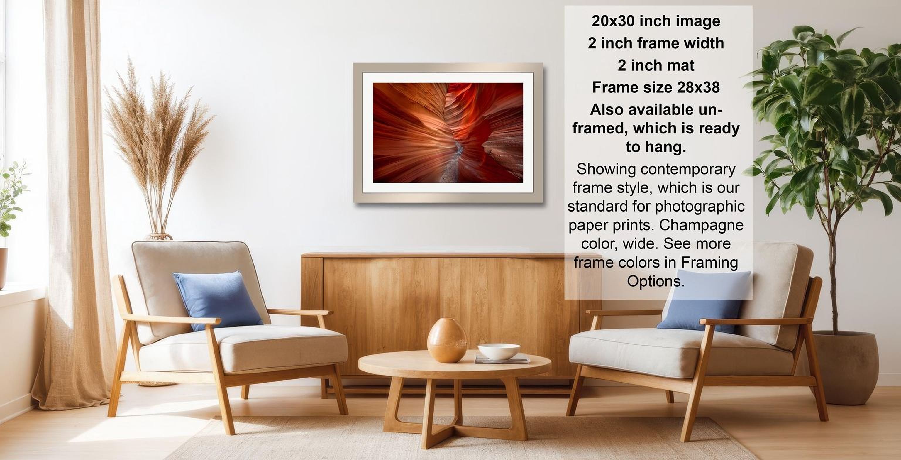 a modern living room with a wooden coffee table, two white armchairs, and a framed photograph of a red rock formation hanging on the wall.