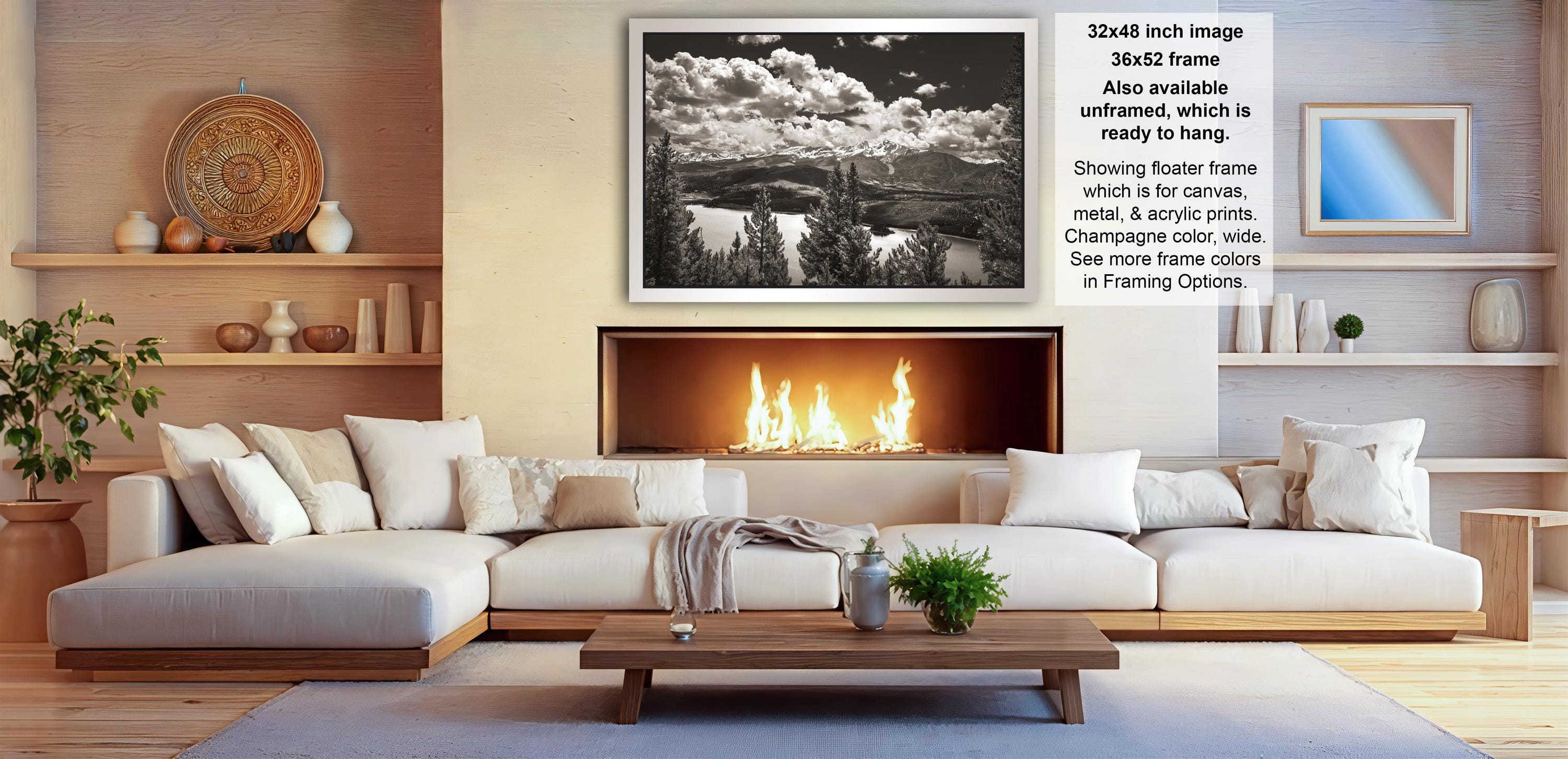 a cozy living room with a fireplace, white sofas, and various decorative elements such as vases and a potted plant.