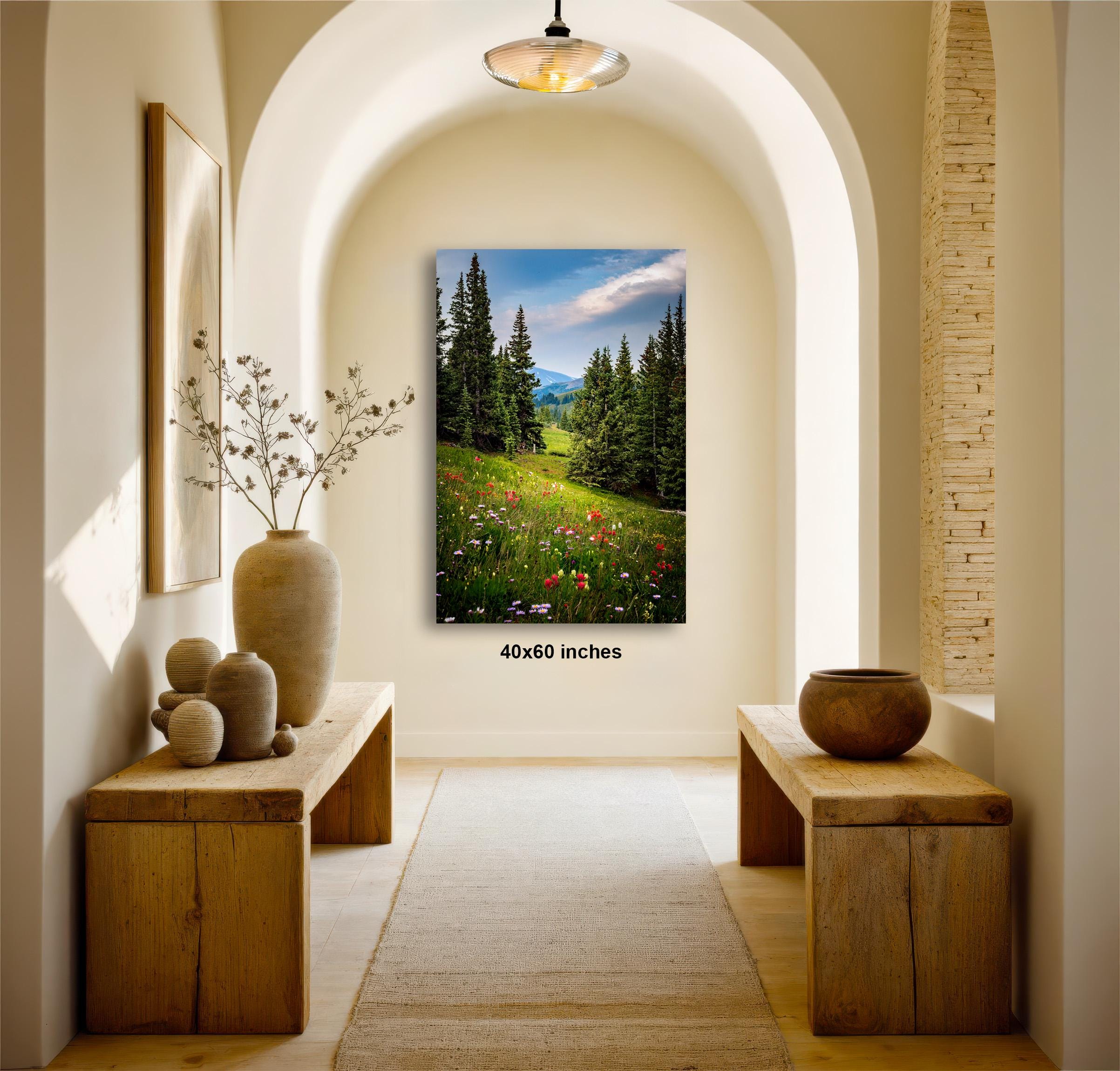 a serene and inviting hallway with a large painting of a lush green field and trees hanging on the wall, creating a peaceful and natural atmosphere.