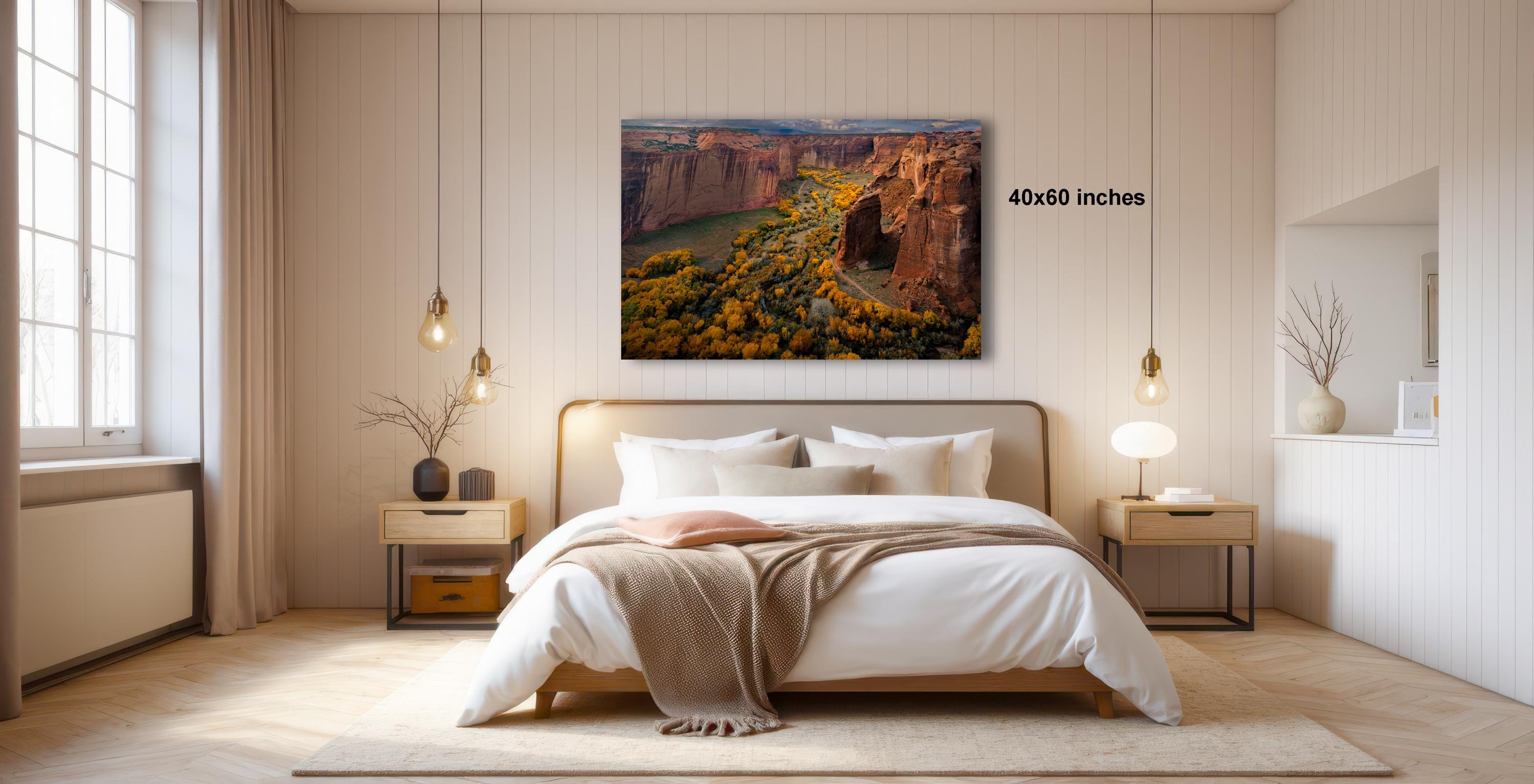 a serene bedroom with a large bed, wooden furniture, and a painting of a scenic landscape hanging on the wall.
