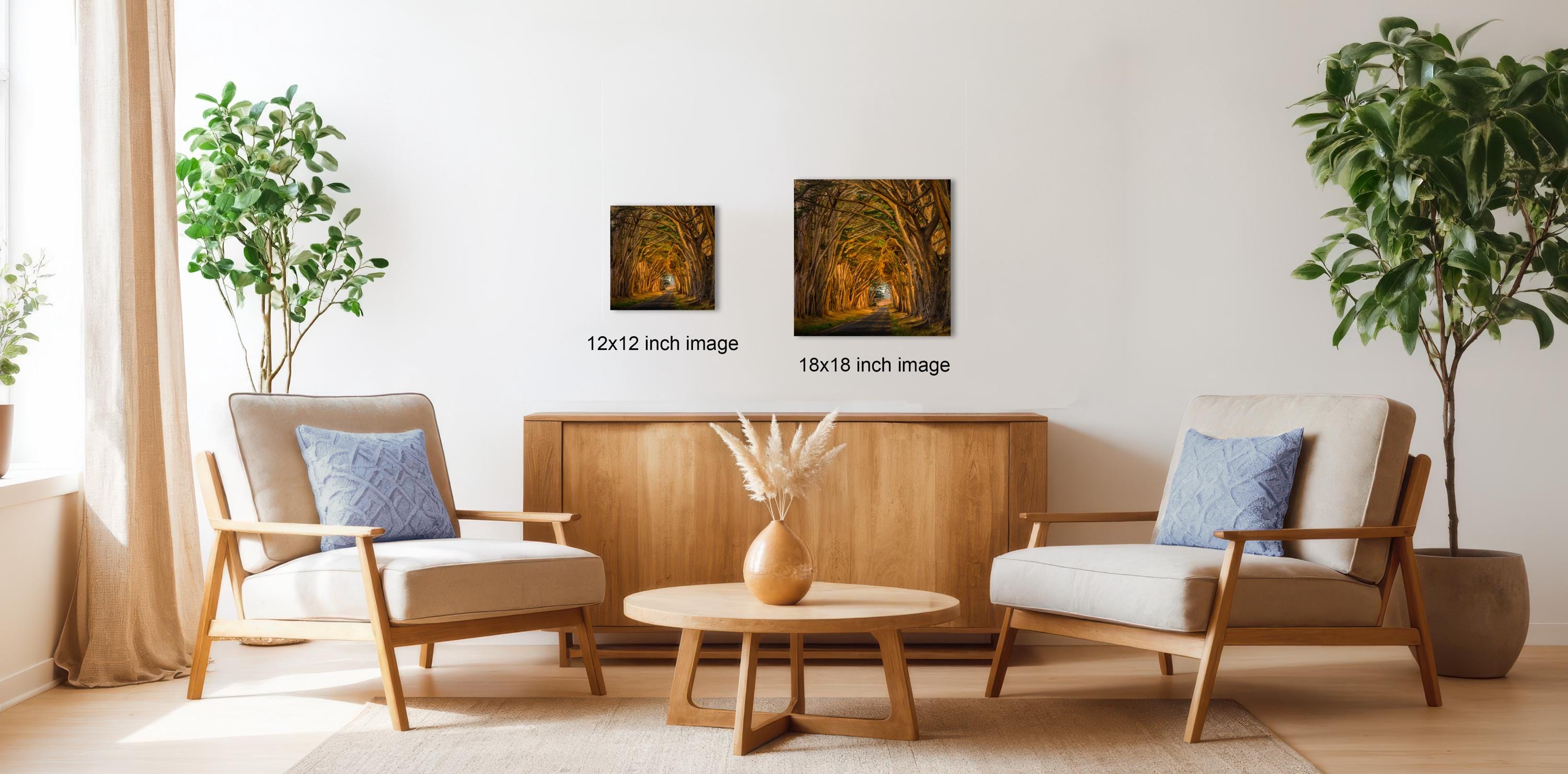 a cozy living room with two comfortable armchairs, a wooden coffee table, and a wooden sideboard. The room is decorated with potted plants and a vase, creating a warm and inviting atmosphere.