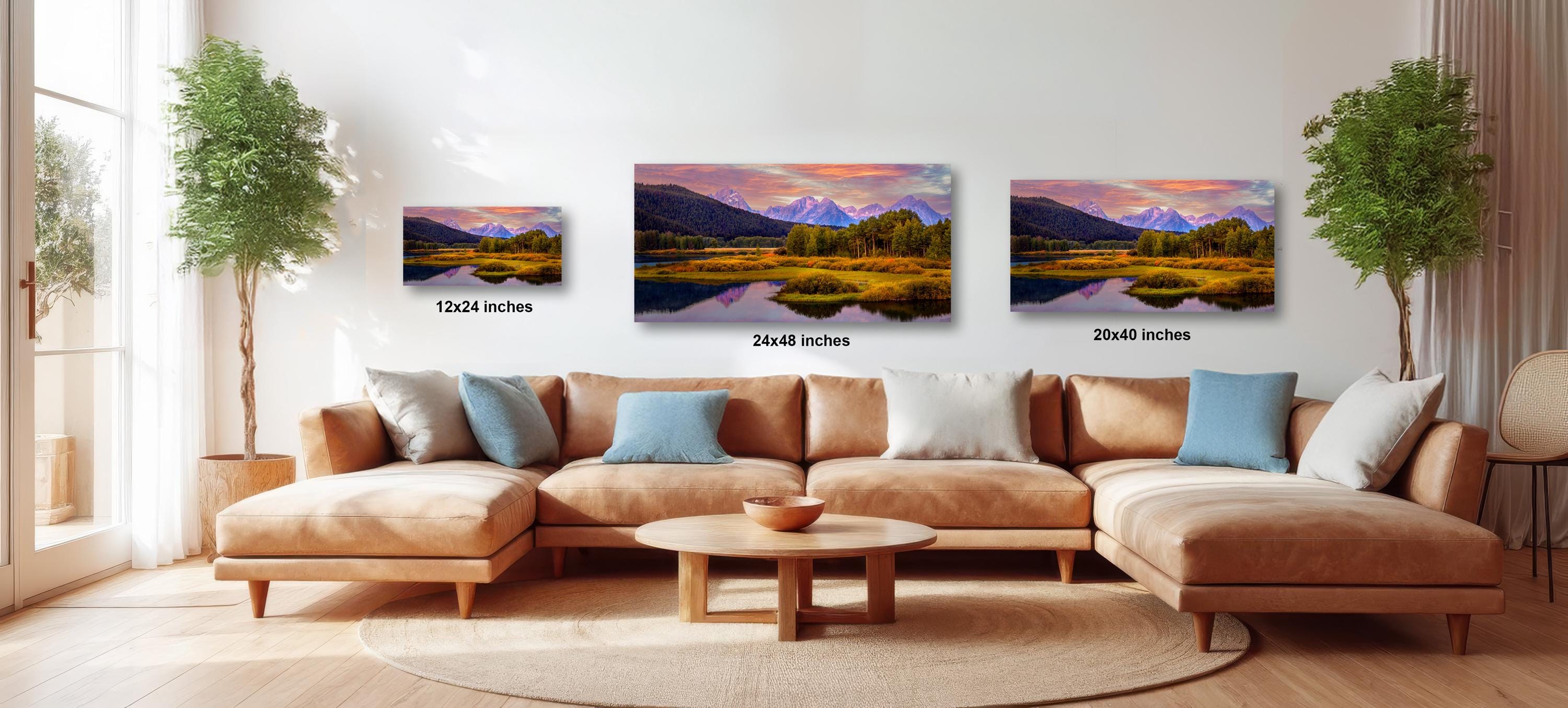 The image is a modern living room with a large sectional sofa, a coffee table, and three framed landscape paintings hanging on the wall.