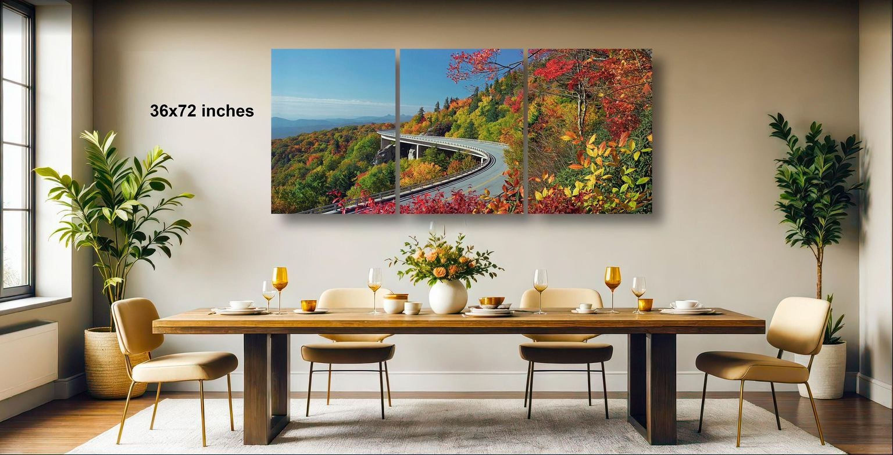 a large, colorful painting of a winding road through a forested mountain landscape, hanging on a wall above a wooden dining table set with wine glasses, plates, and a vase of flowers.