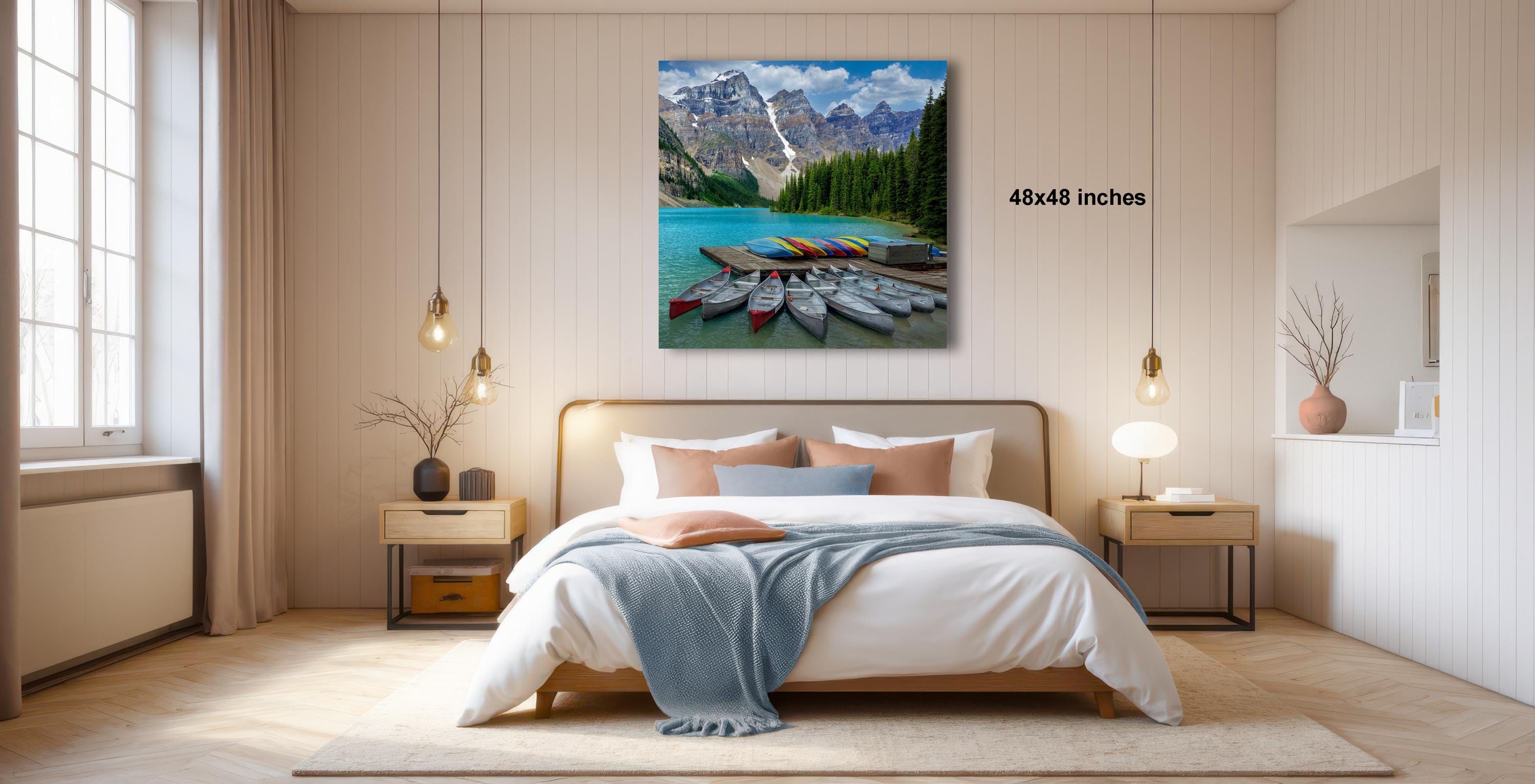 a serene bedroom with a large bed, wooden furniture, and a painting of a mountain lake with boats on the shore.