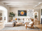 The image is a large framed picture of a water lily on a wall in a living room.