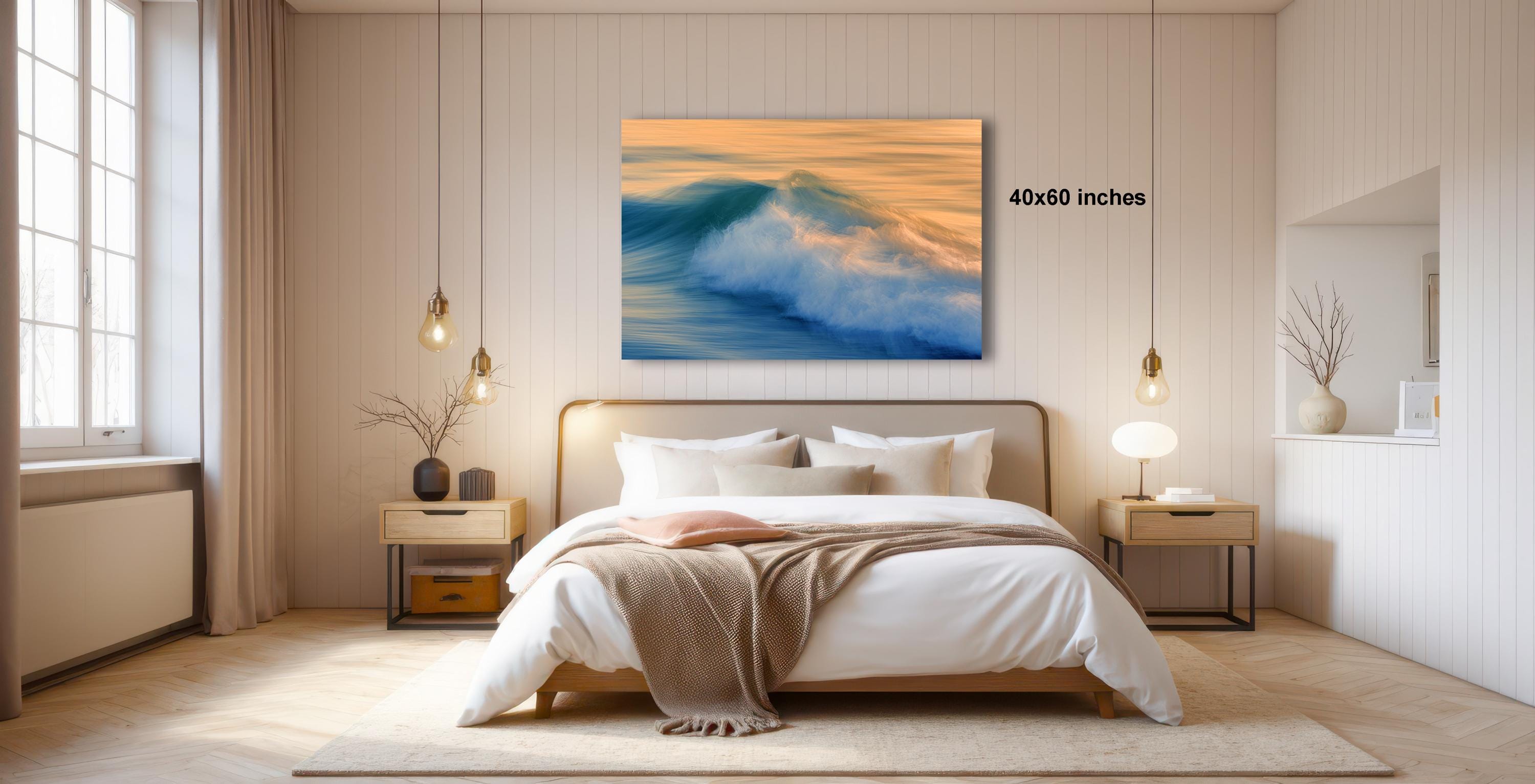 a serene bedroom with a large bed, a nightstand, and a painting of a crashing wave hanging on the wall.