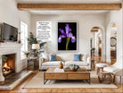 a cozy living room with a fireplace, a large framed photograph of a purple iris, a white sofa, a coffee table, and various decorative elements such as potted plants and vases.