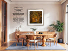 The image is a modern living room with a dining table, chairs, and a potted plant. The room has a minimalist and clean design, with a large window providing natural light. The focal point of the room is a framed photograph of a forest path, which is hanging on the wall.