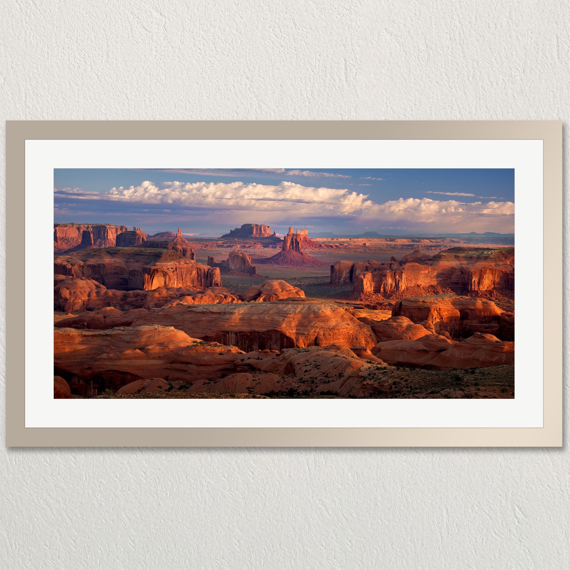 a breathtaking view of a desert landscape with towering red rock formations and a vast expanse of sky.