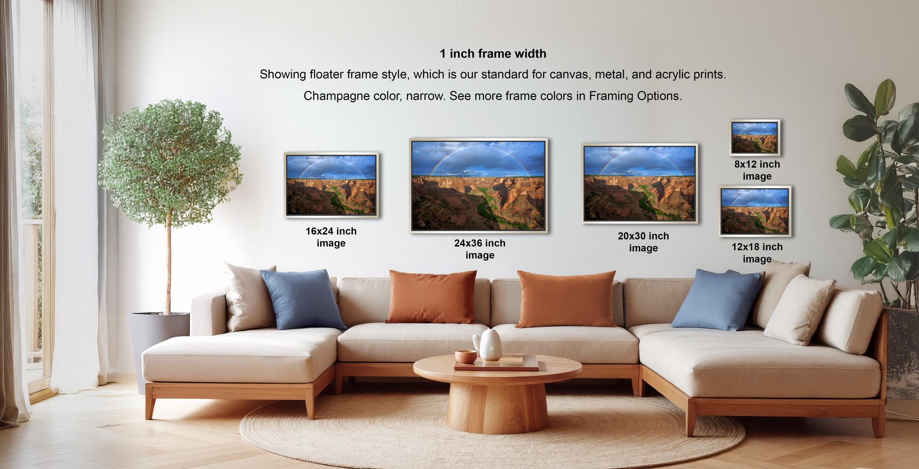 a living room with a large sectional sofa and a coffee table. There are four framed landscape photographs displayed on the wall, each with a different frame size ranging from 16.26 to 12.18 inches. The photographs depict various scenic outdoor landscapes, such as mountains, forests, and grassy areas. The arrangement of the photographs and the overall layout of the living room create a cozy and inviting atmosphere.