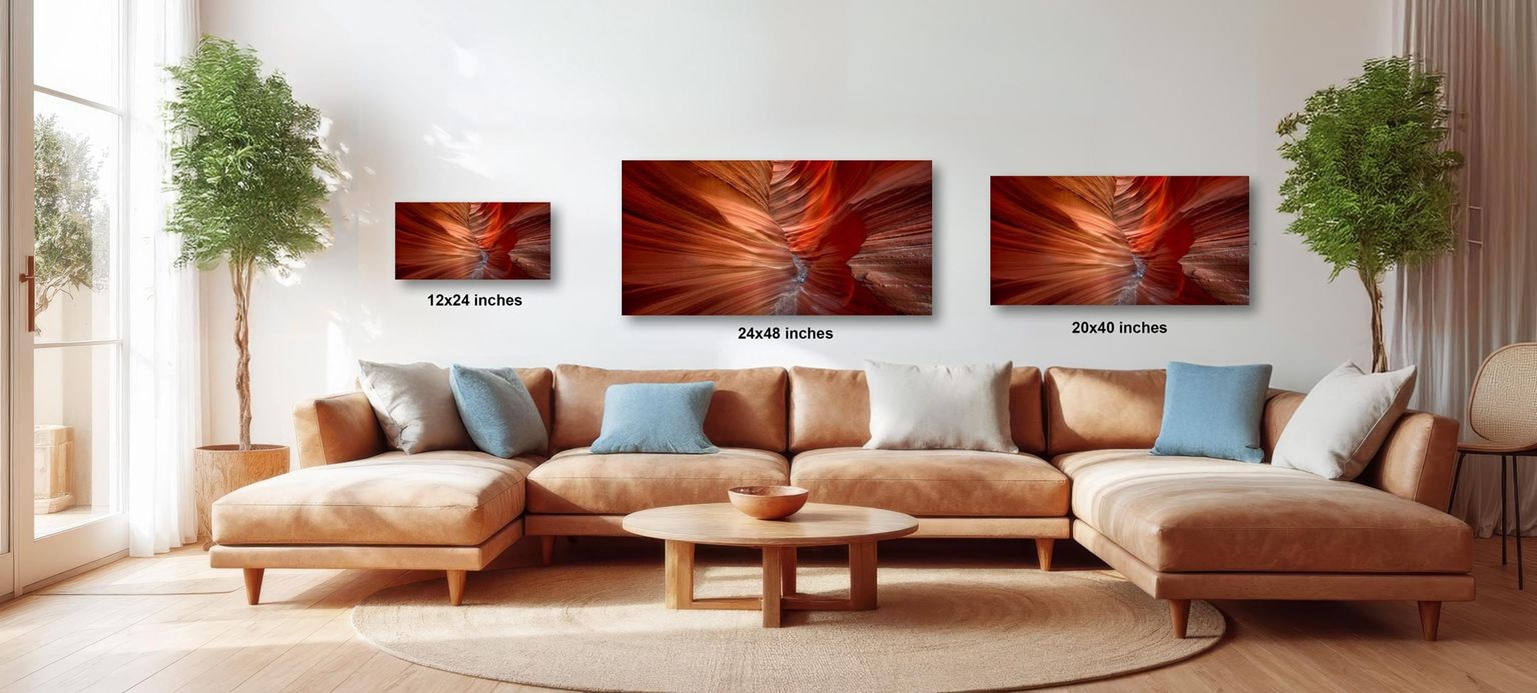 a modern living room with a large sectional sofa, a coffee table, and three framed photographs of abstract landscapes hanging on the wall.