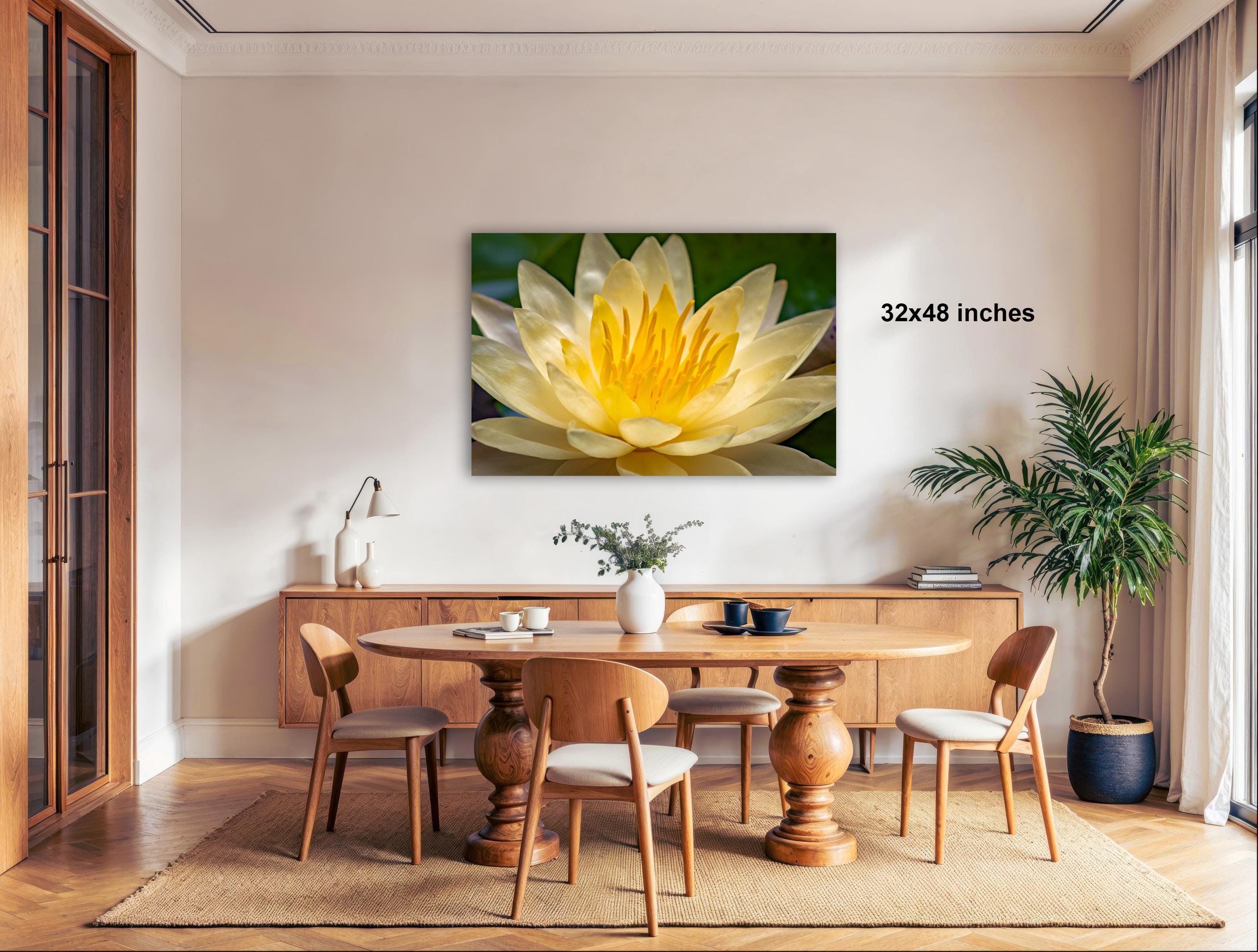 a large, vibrant yellow flower on a wall, with a dining table and chairs in the foreground.