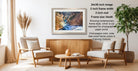 a living room with a wooden coffee table, two white armchairs, and a framed photograph of a waterfall hanging on the wall.