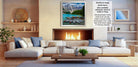 a cozy living room with a fireplace, a large white sofa, and a coffee table. The room has a warm and inviting atmosphere, with a fireplace providing a focal point and a painting of a scenic mountain landscape hanging on the wall.