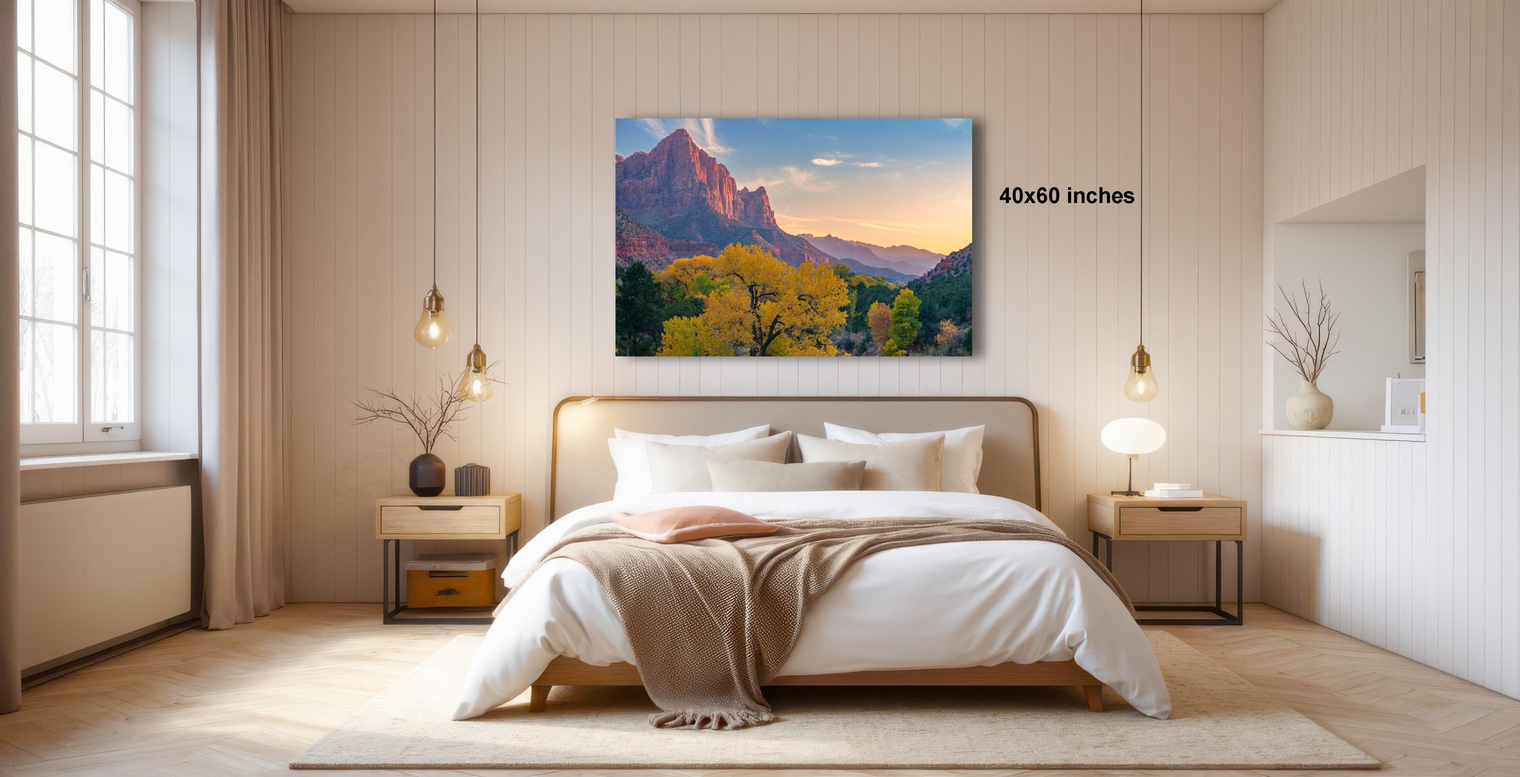 a serene bedroom with a large bed, wooden furniture, and a painting of a mountain landscape hanging on the wall.