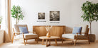 a cozy living room with two comfortable armchairs, a wooden coffee table, and two potted plants. The room is decorated with a wooden cabinet and a vase of flowers, creating a warm and inviting atmosphere.