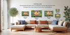 The image is a living room with a large sectional sofa and a coffee table. There are four framed photographs of a pink lotus flower displayed on the wall, each with a different frame size ranging from 16" to 20" inches. The wall also features text providing information about the frame widths and the standard for canvas, metal, and acrylic prints.