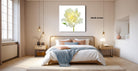 A modern bedroom with a large bed, wooden nightstands, and a large window. The room has a minimalist and clean design, with a large white flower painting hanging on the wall above the bed.