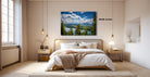 a serene bedroom with a large bed, wooden furniture, and a framed landscape photograph hanging on the wall.