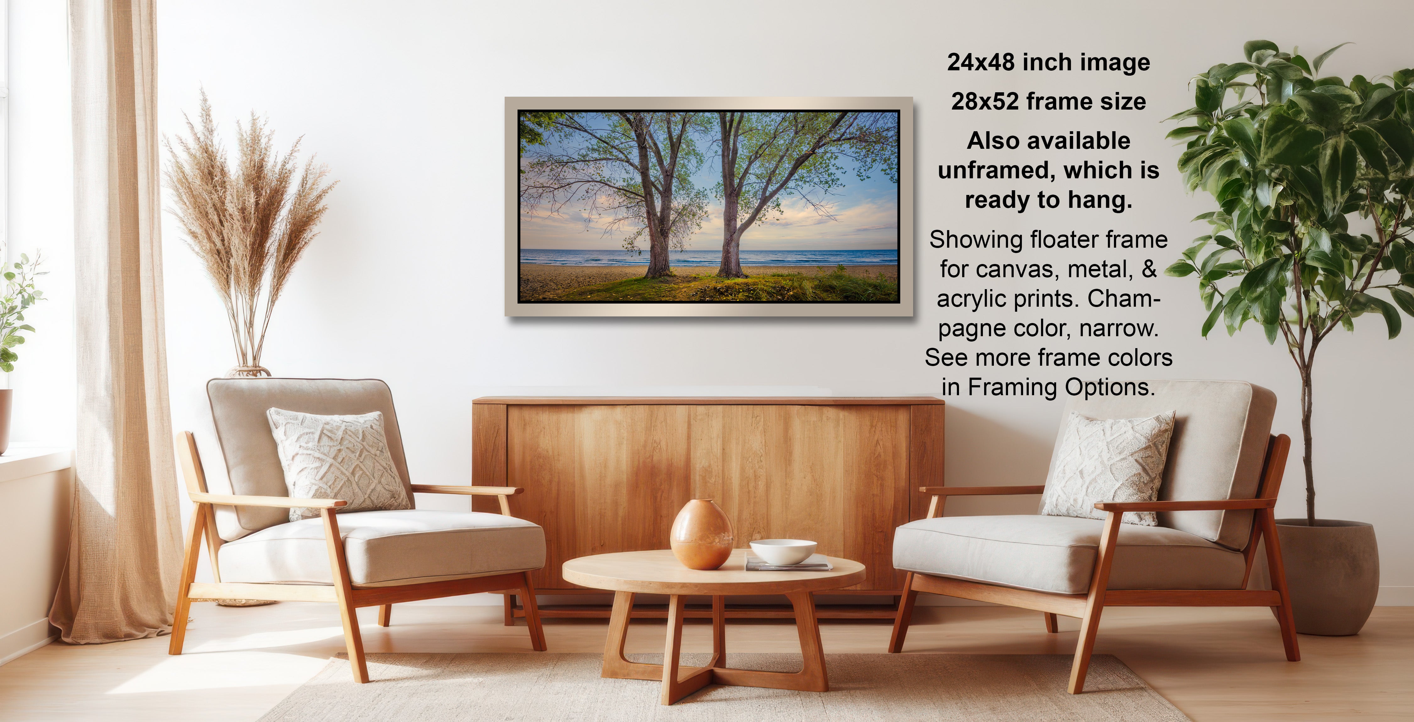 a living room with a wooden coffee table, two white armchairs, and a framed landscape photograph hanging on the wall.