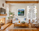 The image is a living room with a fireplace, a television, a sofa, and a coffee table. There is a framed picture of a mountain landscape hanging on the wall, and a text overlay providing information about the frame size and color options.
