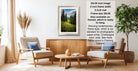 a living room with a framed landscape photograph hanging on the wall, a wooden coffee table in the center, and two chairs facing each other.