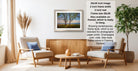 The image is a living room with two chairs, a coffee table, and a framed landscape photograph hanging on the wall. The photograph is framed in a modern style and is ready to hang.