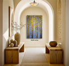 a hallway with a large painting of a forest scene hanging on the wall. The painting is framed in a square format and measures 4060 inches in height. The hallway features wooden benches and tables, as well as decorative elements such as vases and a potted plant. The overall atmosphere of the scene is serene and natural, with the painting serving as a focal point in the space.